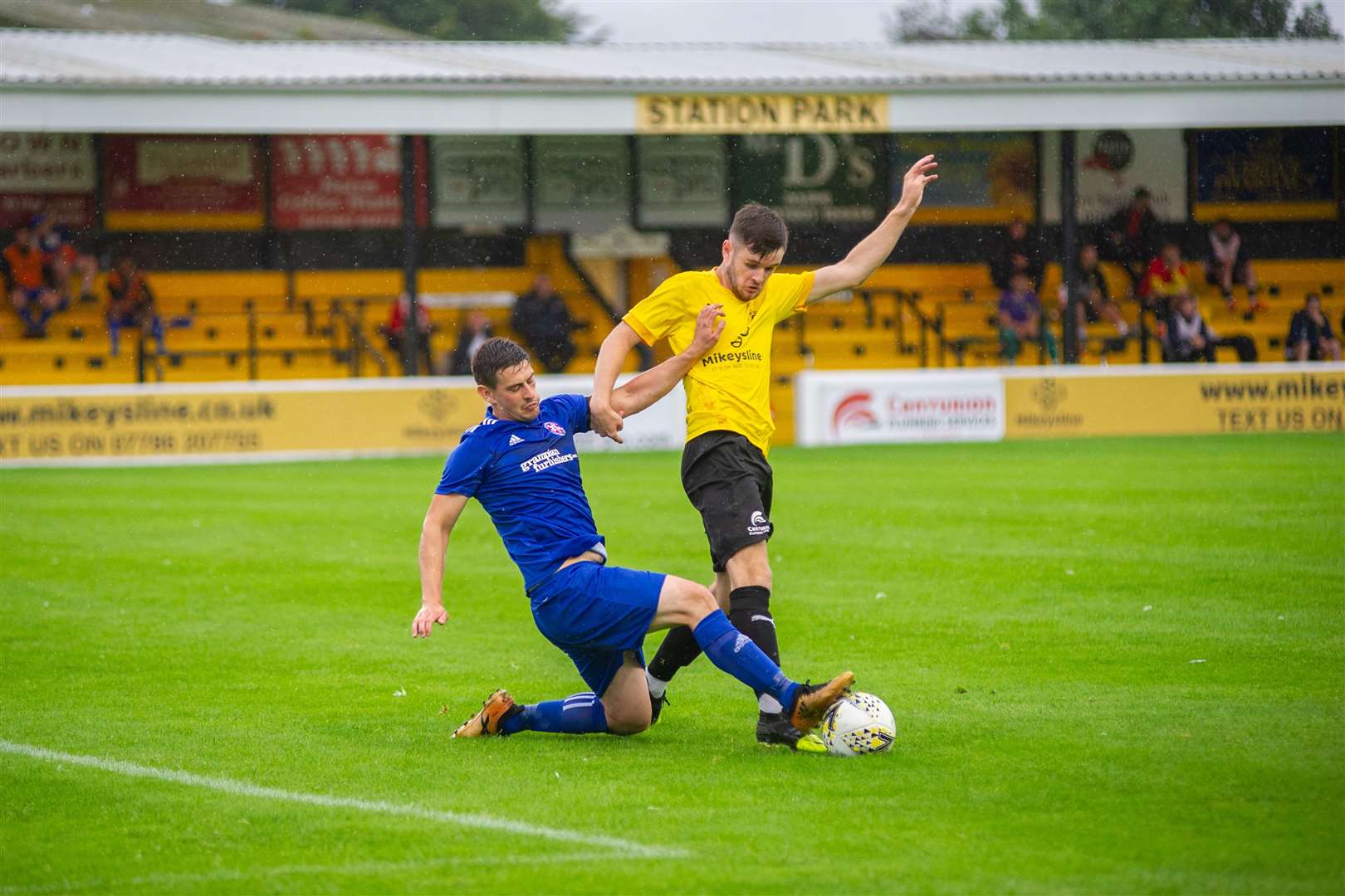 Lossie skipper Liam Archibald goes in for a challenge on Nairn County's Dylan MacKenzie...Nairn County FC (2) vs Lossiemouth FC (4) - North of Scotland Cup first round - Station Park, Nairn 28/07/2021...Picture: Daniel Forsyth..