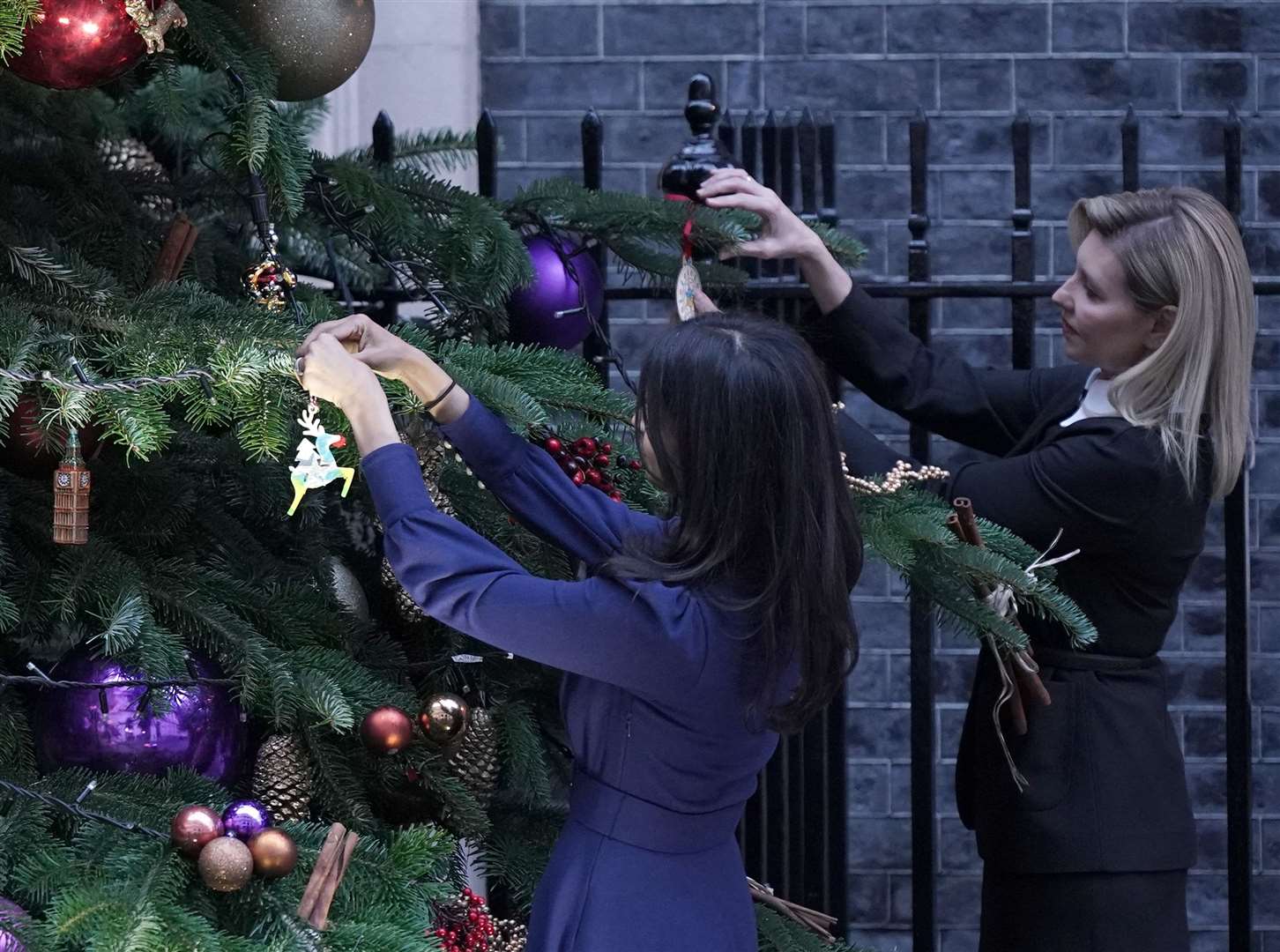 First Lady of Ukraine Olena Zelenska (right) hangs a decoration to the Christmas tree in Downing Street, with Rishi Sunak’s wife, Akshata Murty (Yui Mok/PA)