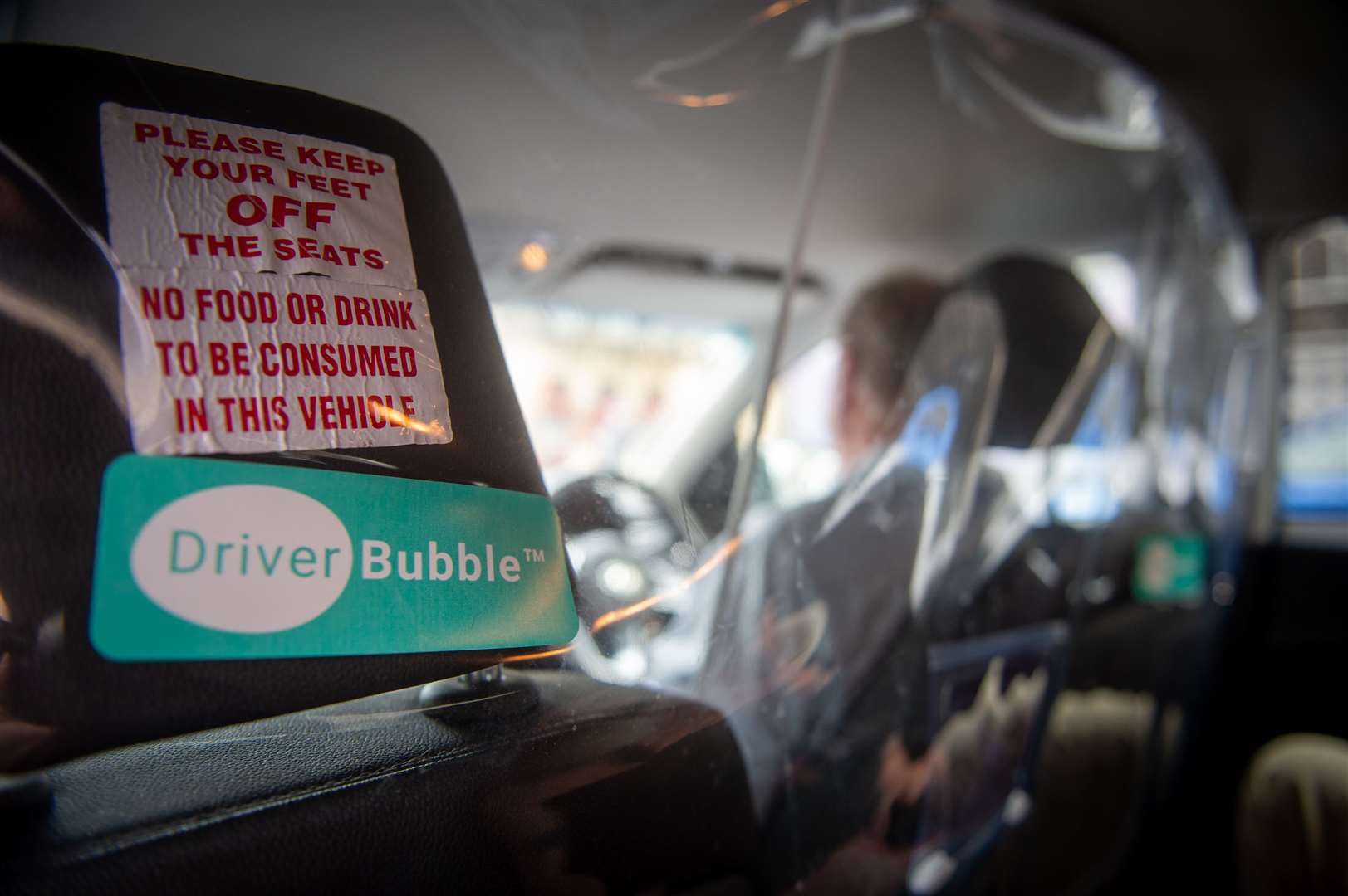 Safety measures introduced in taxis because of the pandemic – all cabs are fitted with a plastic driver bubble and passengers must wear masks.