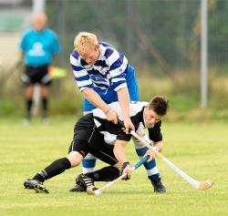 Newtonmore's Jamie Robinson piles on the pressure for Lovat's Craig Mainland in his side's 5-1 Macaulay Cup semi-final win.