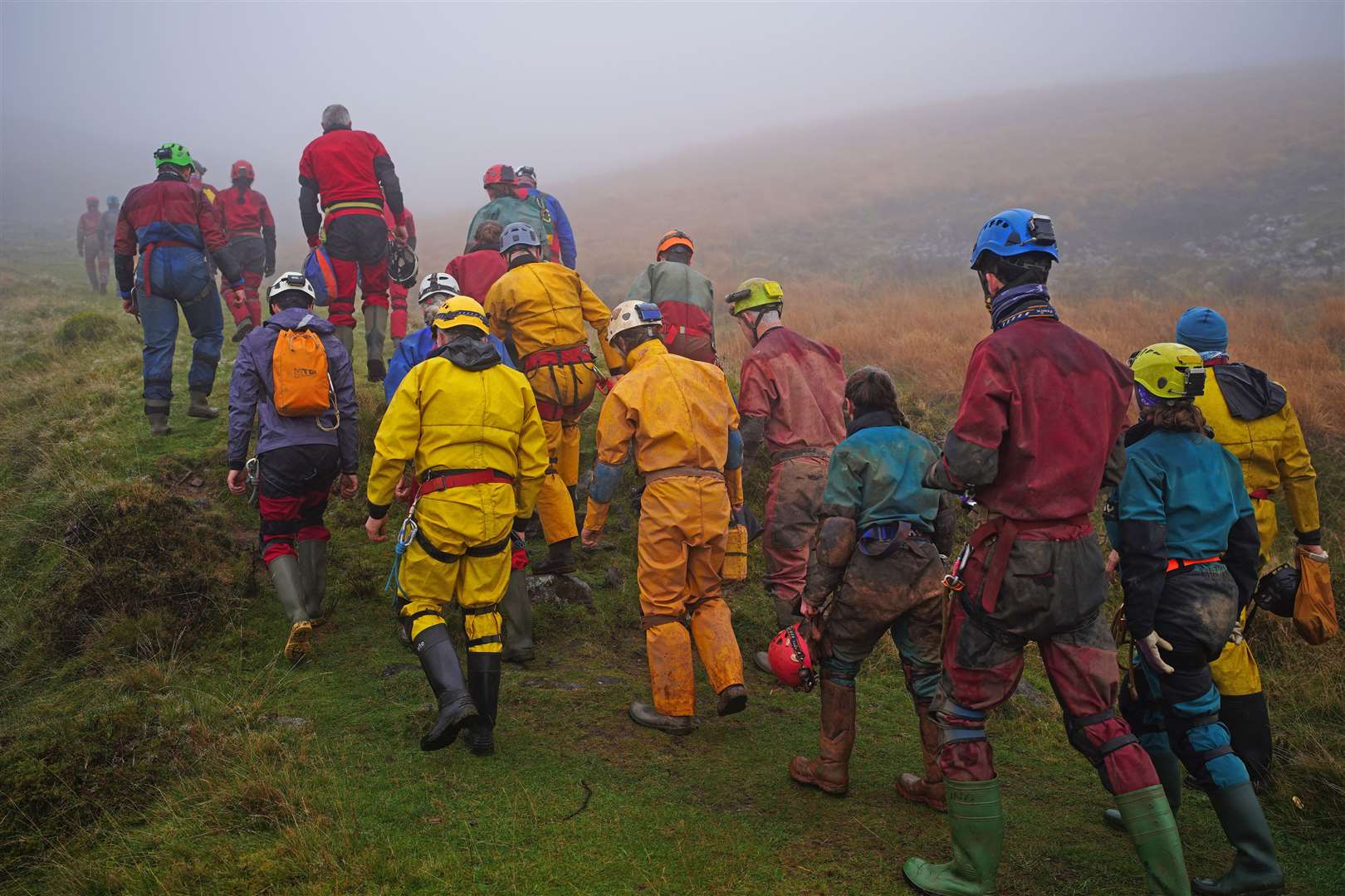 Rescuers walk towards the Ogof Ffynnon Ddu cave system near Penwyllt (Ben Birchall/PA)