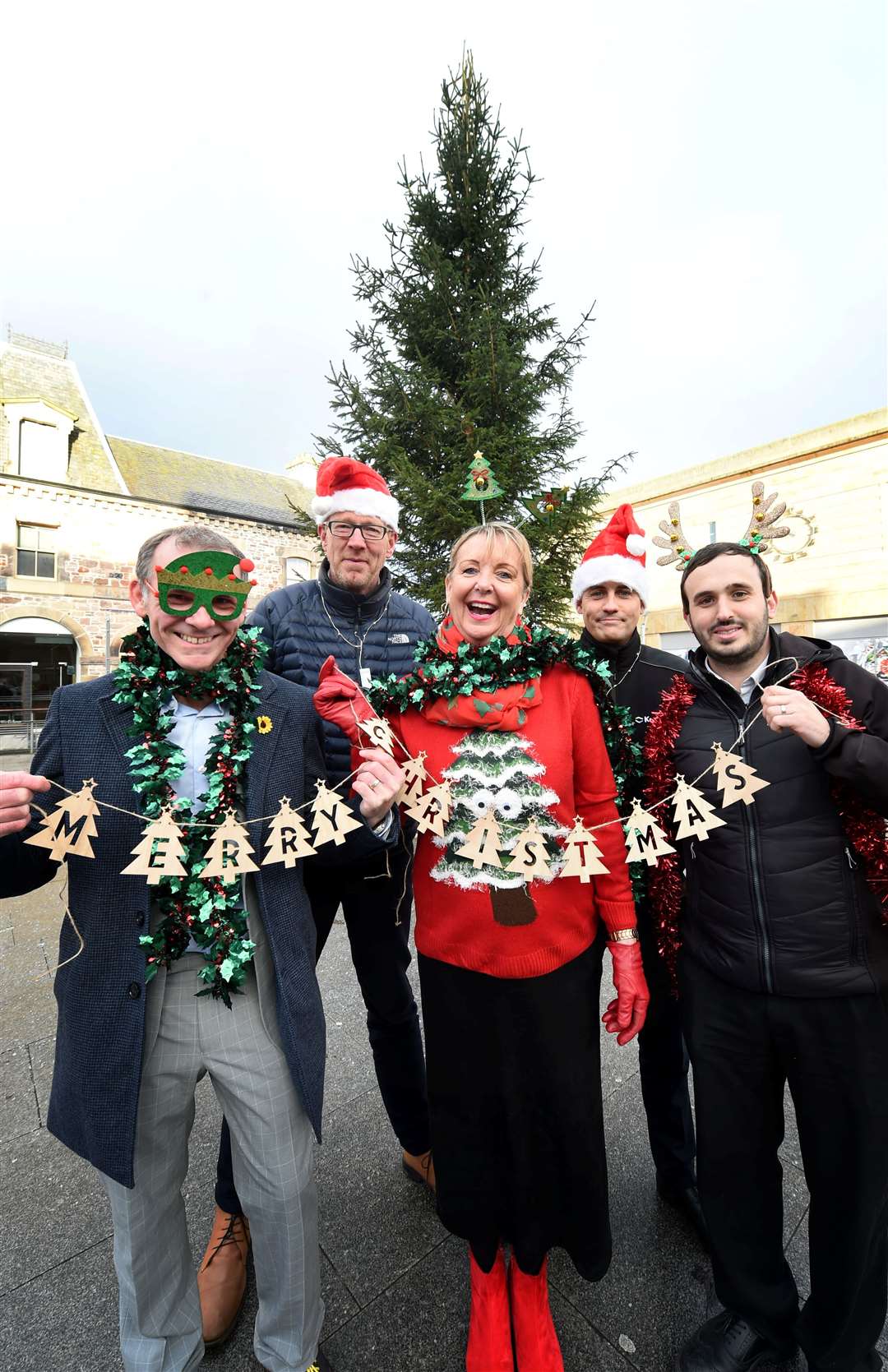 Andrew Leaver of Highland Hospice with Dougal Murray of WGC Scotland, Eastgate Shopping Centre manager Jackie Cuddy and Steven Mitchell and Gavin Gray of Keyline with the Falcon Square tree.