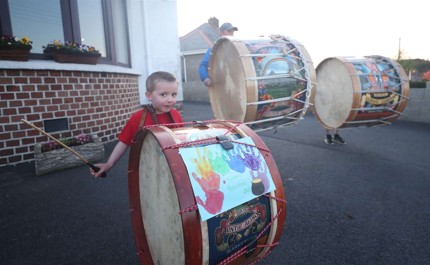 Thomas Black, four, from Market Hill in County Armagh, bangs a Lambeg drum to salute local heroes during a nationwide Clap for Carers initiative to recognise and support NHS workers and carers fighting the coronavirus pandemic (Niall Carson/PA)