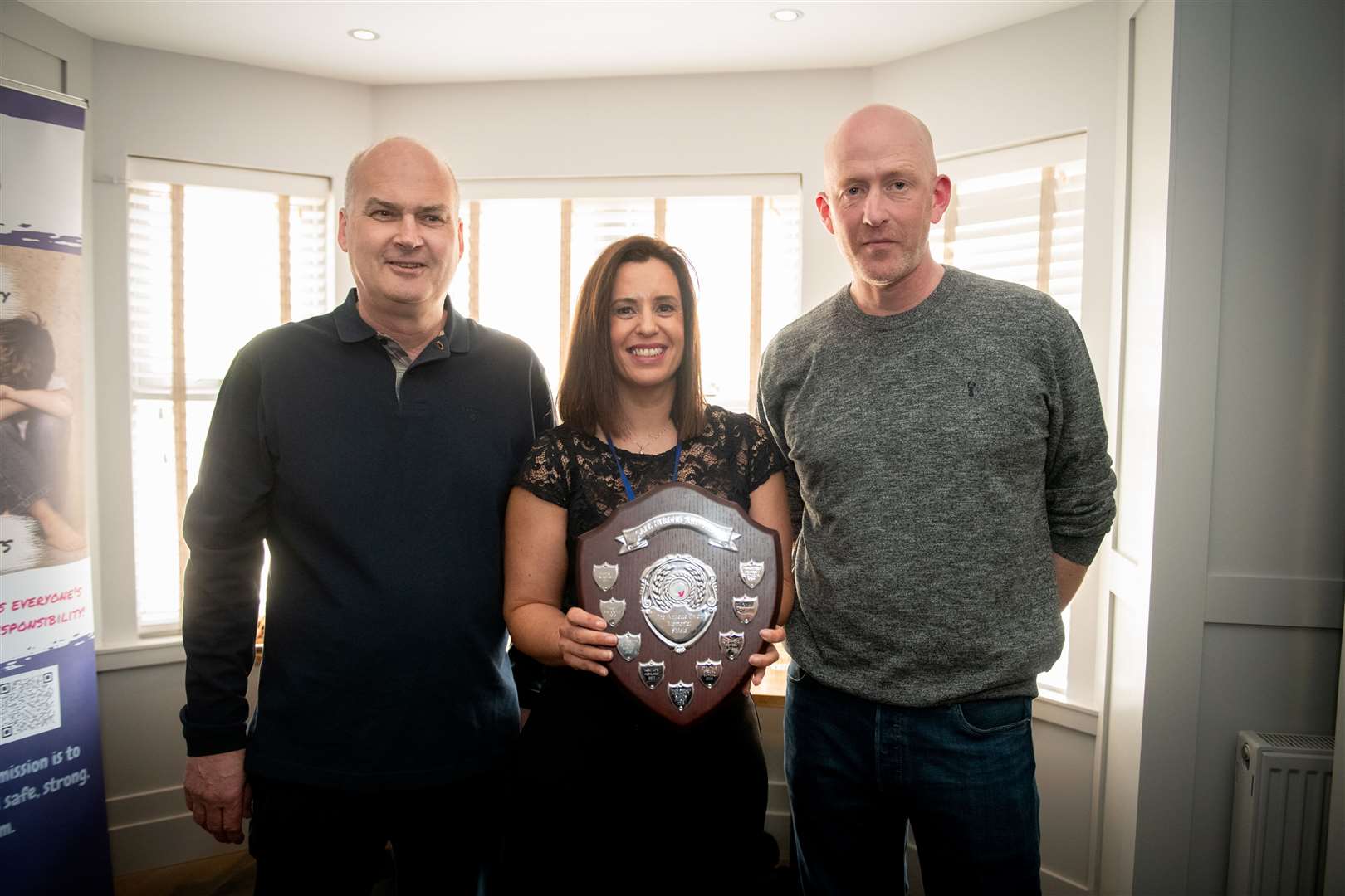 Paul Mackintosh (right) who recently climbed Mount Kilimanjaro on behalf of Safe, Strong and Free being presented with Annette Ewen Memorial Shield by Managing Director Donald Maclachlan and Project Manager Kerry Lowe. Picture: Callum Mackay.