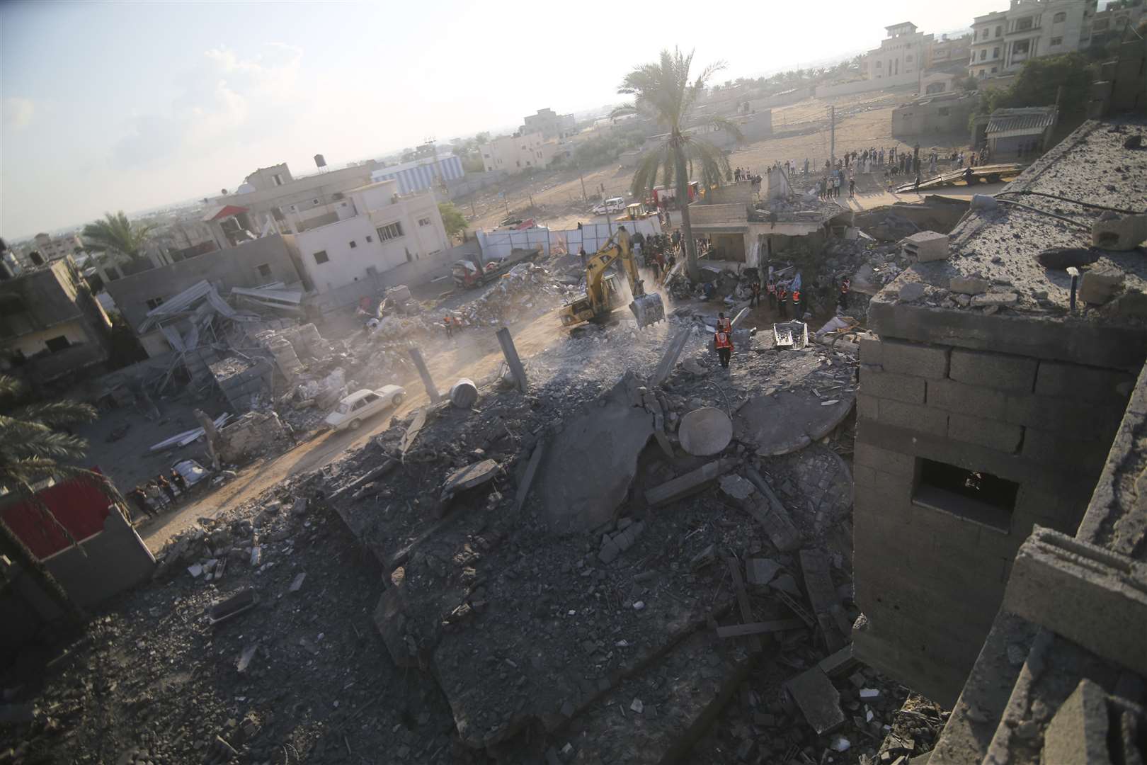 Palestinians clear the rubble of a building destroyed in an Israeli airstrike on the Rafah border, Gaza Strip (Hatem Ali/AP/PA)