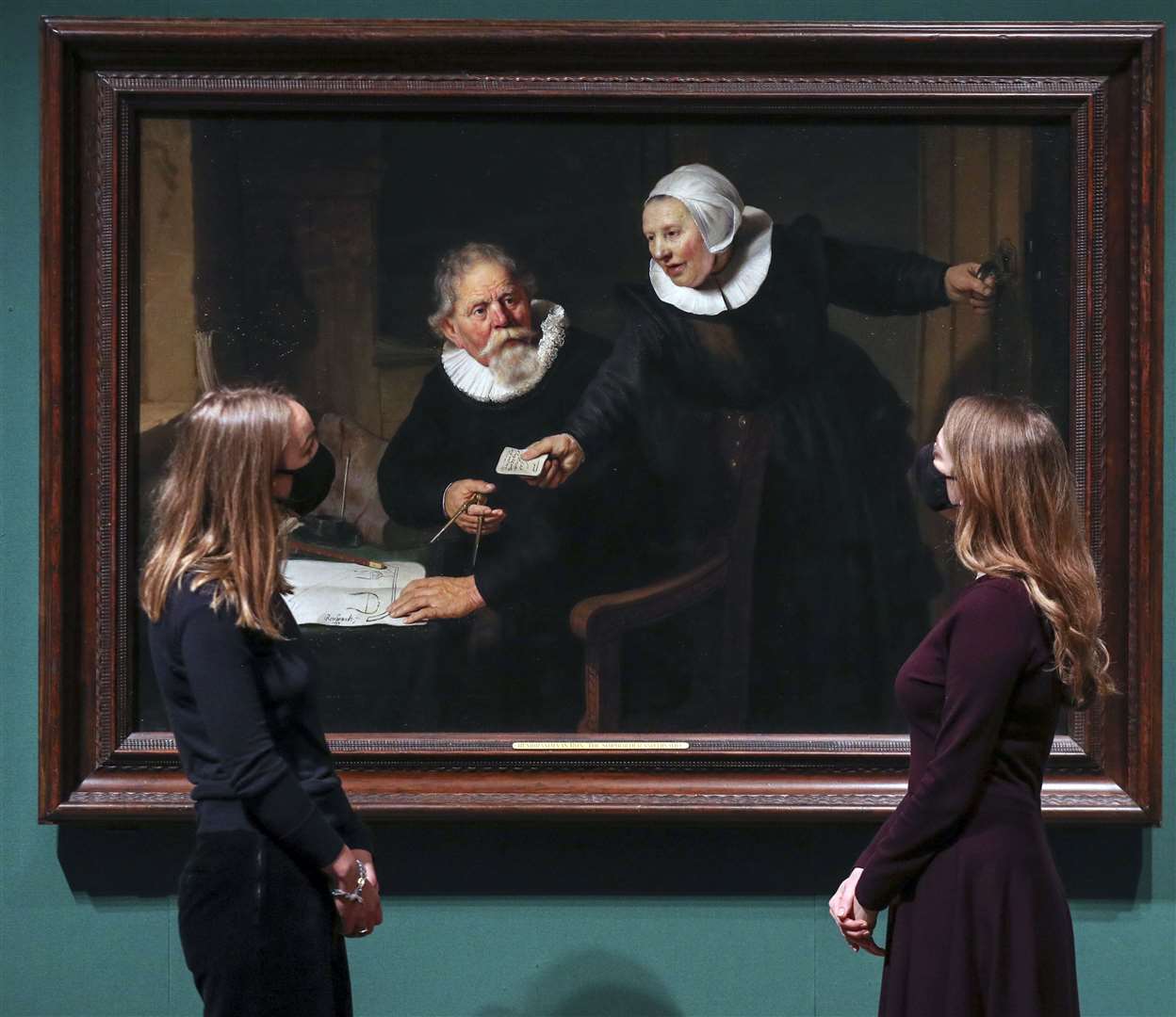Women look at Rembrandt’s painting The Shipbuilder and his Wife (Steve Parsons/PA)
