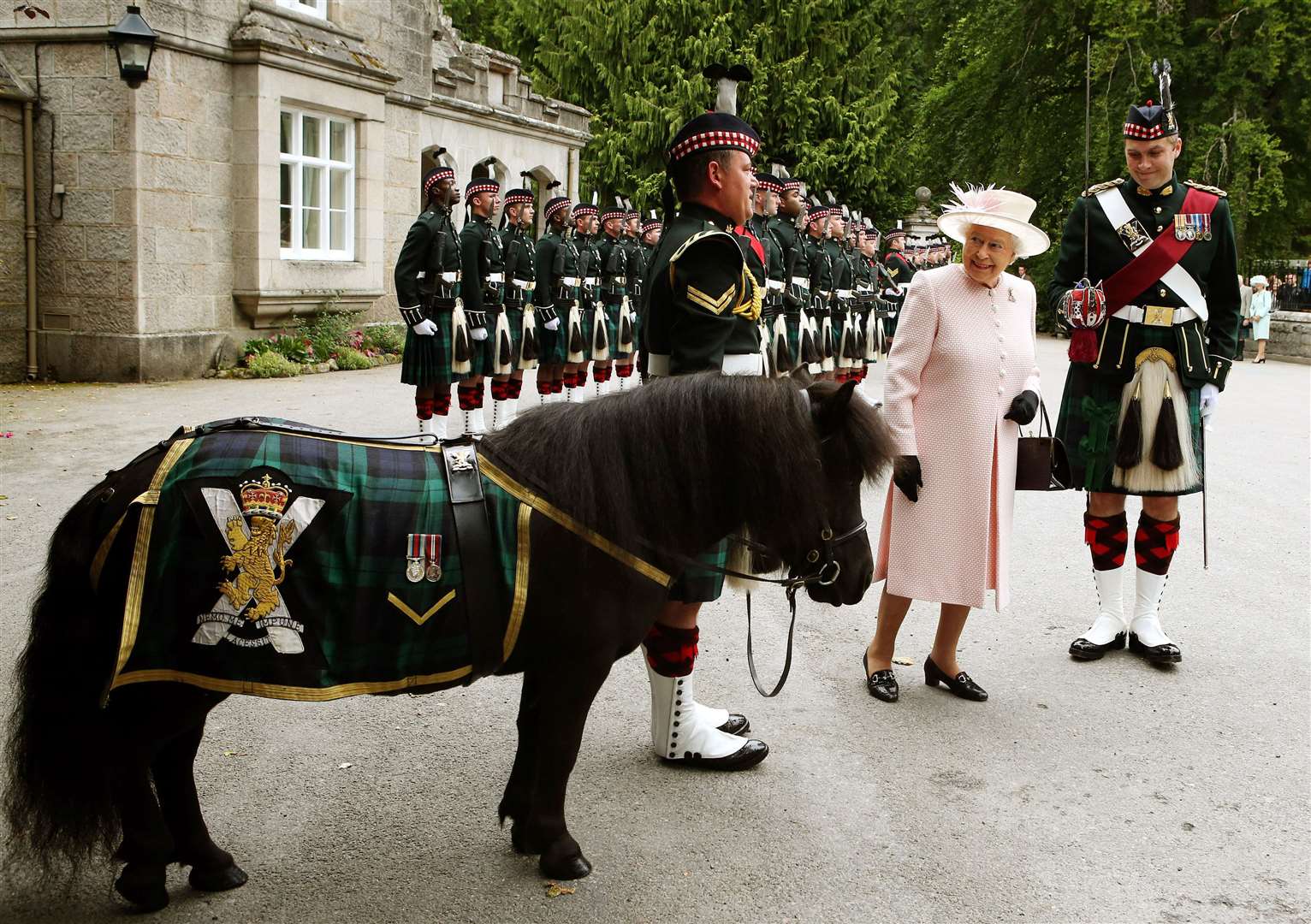 Queen Elizabeth II talks to Pony Major Mark Wilkinson with regimental mascot Cruachan IV, who will lead the people’s procession (Andrew Milligan/PA)