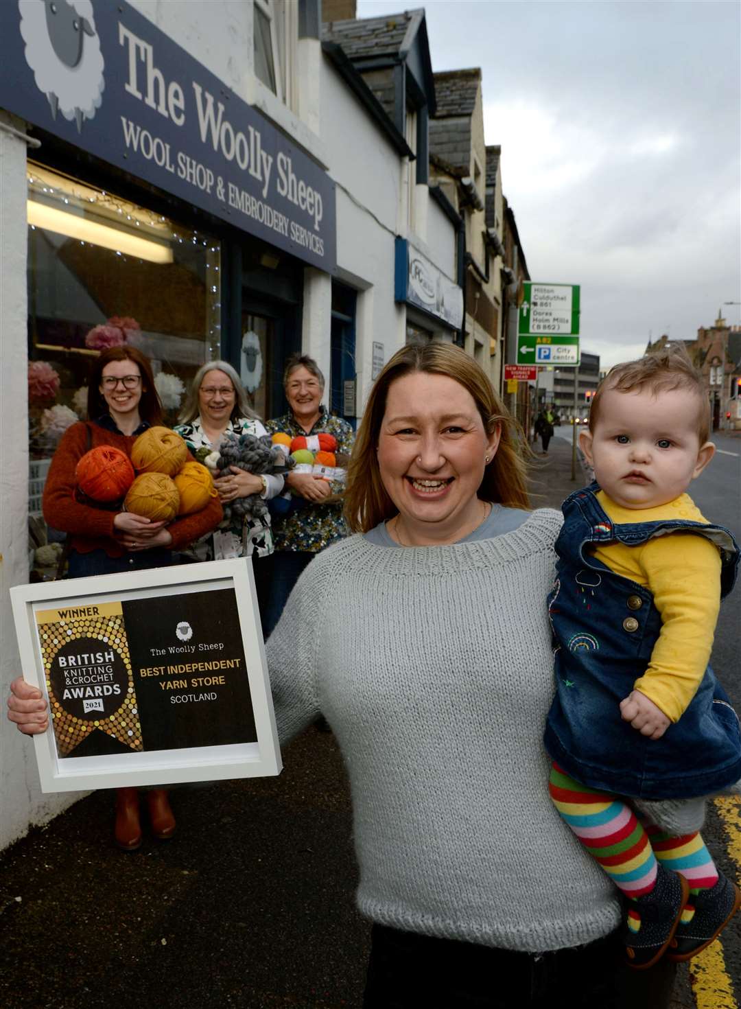 The Woolly Sheep owner Naomi Whyte and daughter Ruby Rae Edwards proudly display the shop's best independent yarn store in Scotland award from the British Knitting & Crochet Awards 2021 watched by Mary-Anne Thomson, Pearl Whyte and Andrea Gritter. Picture: James Mackenzie