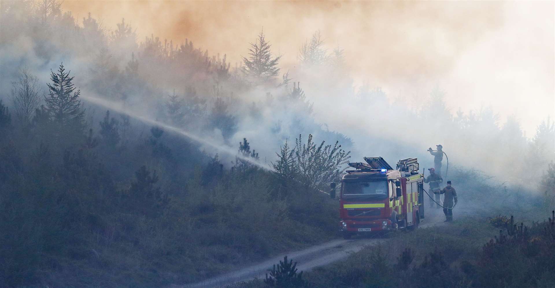 Firefighters tackle a gorse fire in Newry in April (Niall Carson/PA)