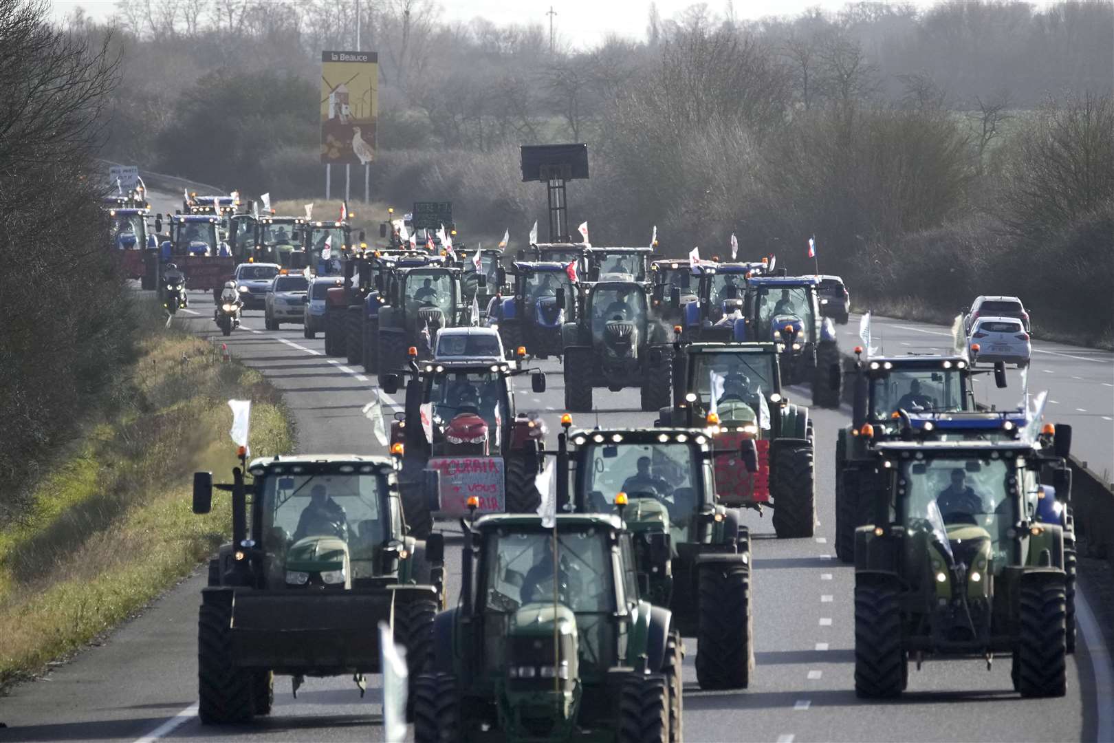 Farmers drive their tractors on a motorway near Saint-Arnoult, south of Paris on their way to a blockade (Christophe Ena/AP)
