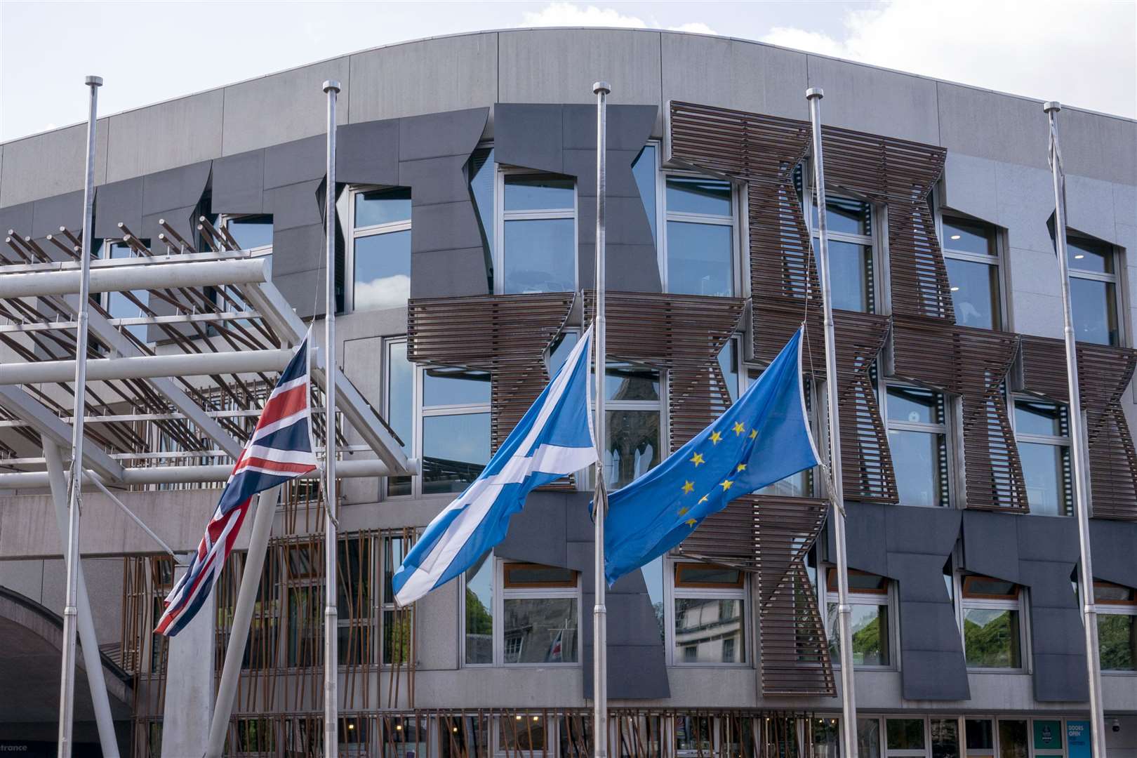 Flags fly at half-mast outside the Scottish Parliament in Holyrood after Mrs Ewing’s death (PA)