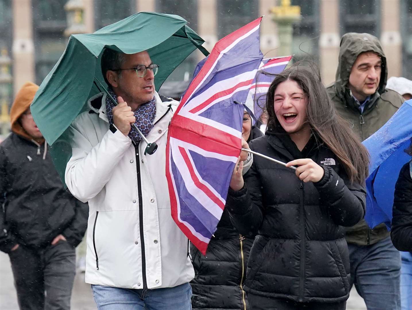 People brave the wind and rain on Westminster Bridge in London on Easter Monday (Jonathan Brady/PA).