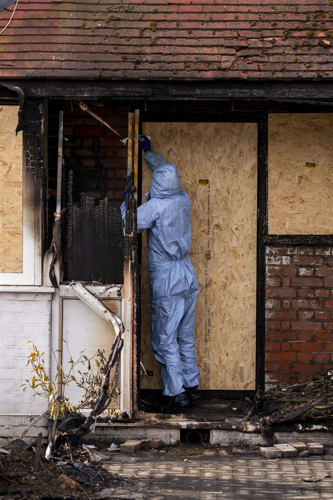 A forensic officer carries out investigations at the scene of a fatal house fire in Streatham (Jordan Pettitt/PA)