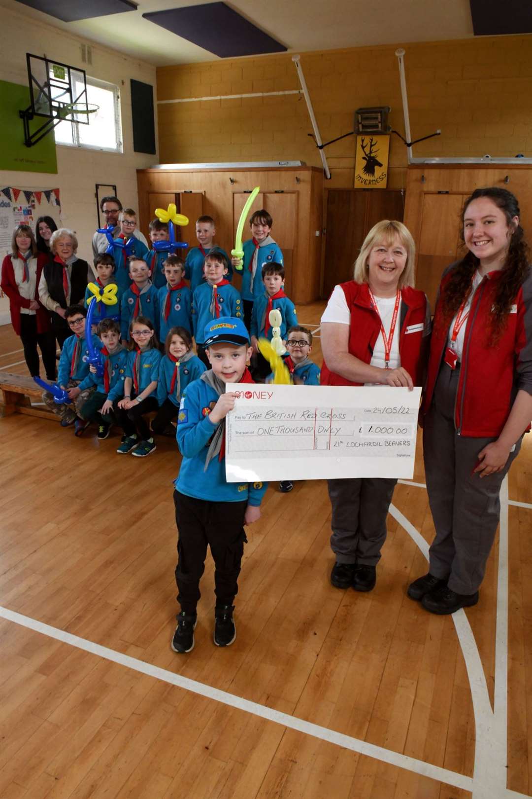 Struan Mackay on his last day of Beavers handing over the cheque to Fiona and Molly McDiarmid, British Red Cross Emergency Response Volunteers. Picture: James Mackenzie