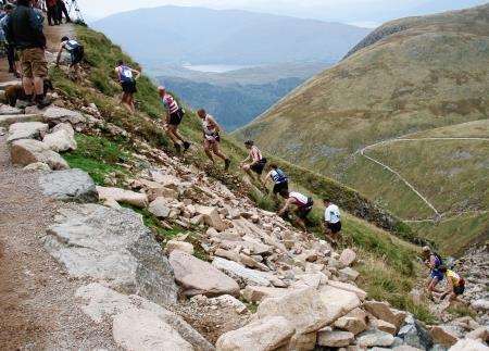 Runners make their way up the steep zigzags towards the summit of Ben Nevis.