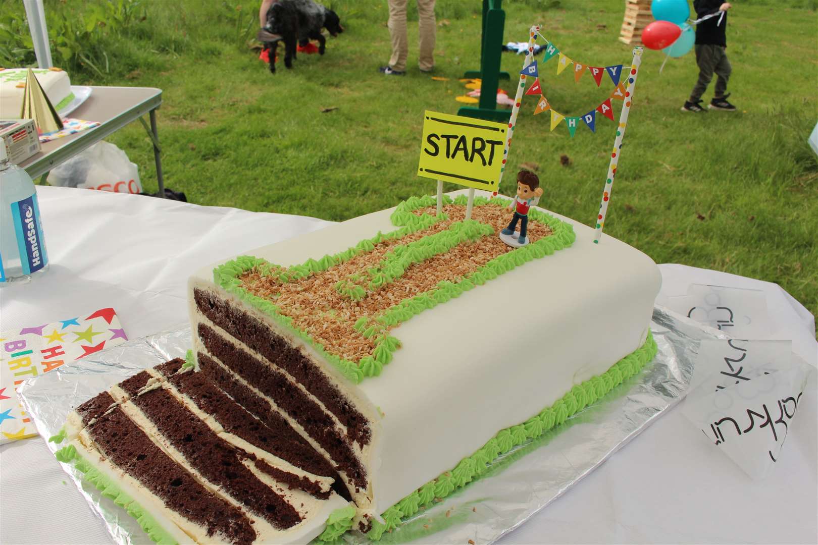 The birthday cake is cut to mark the first year of the Torvean junior parkrun.