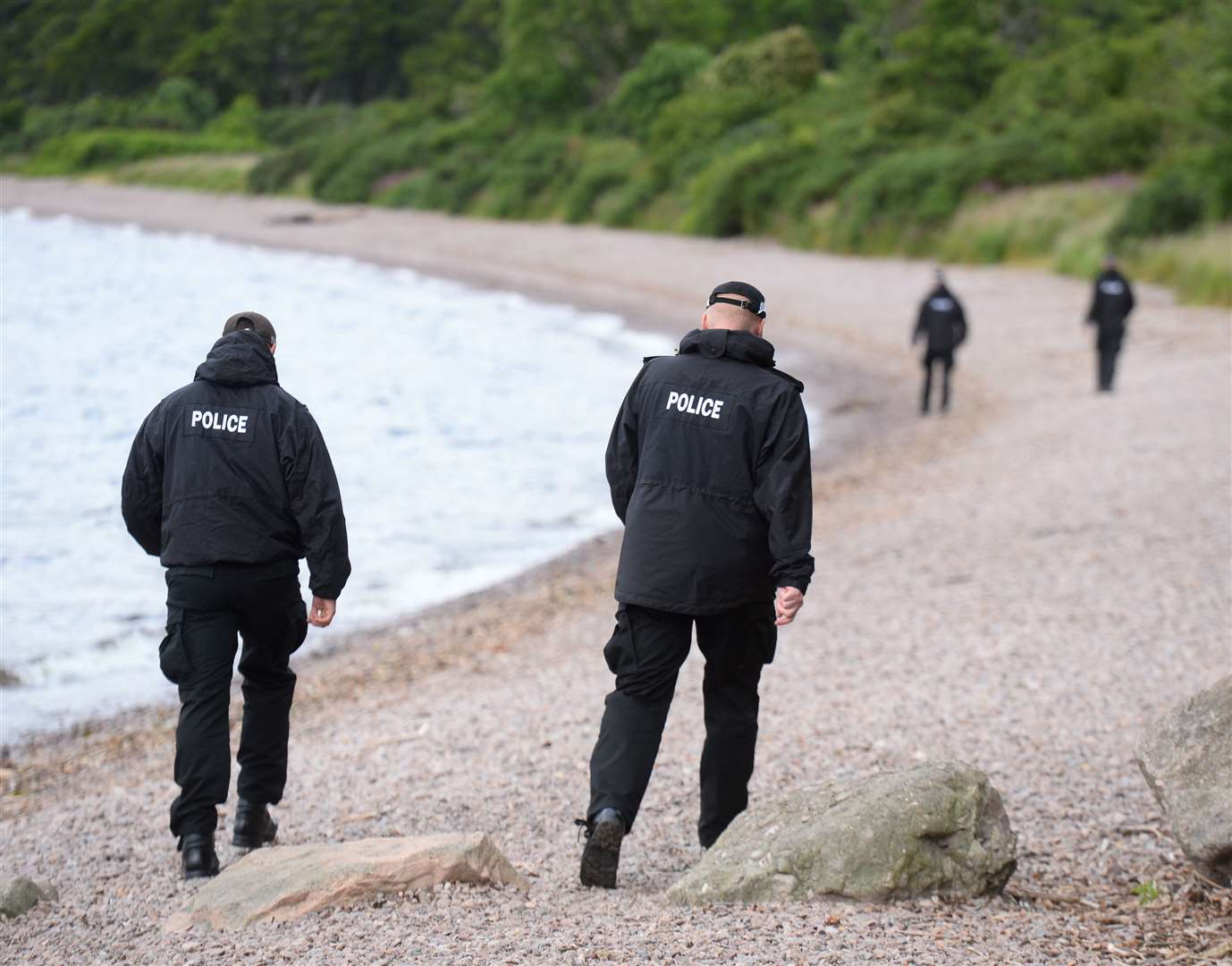 Police searching the shoreline at Dores.
