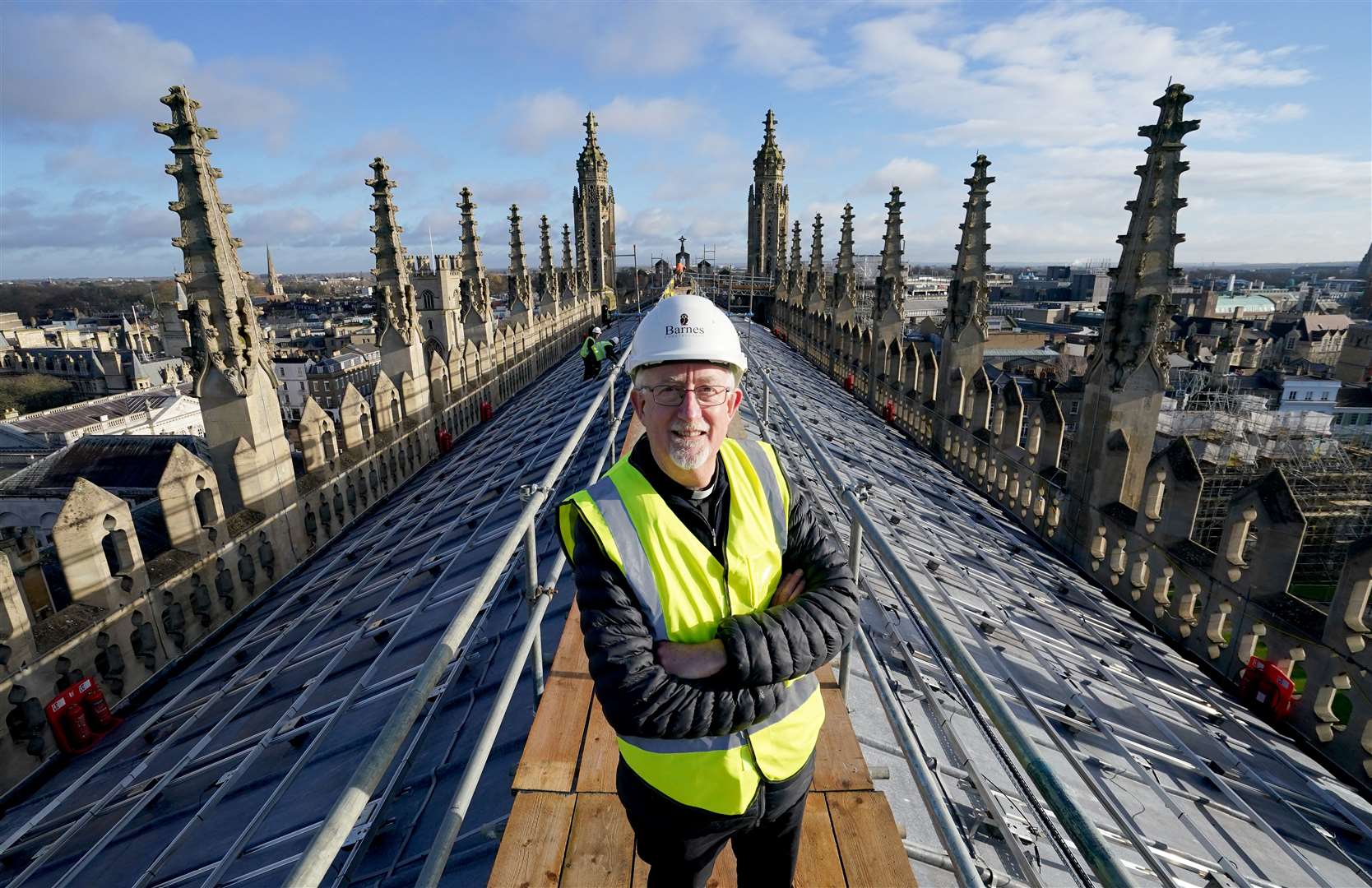 Stephen Cherry, Dean of King’s College Chapel, views the installation of 438 new photovoltaic solar panels (Gareth Fuller/ PA)