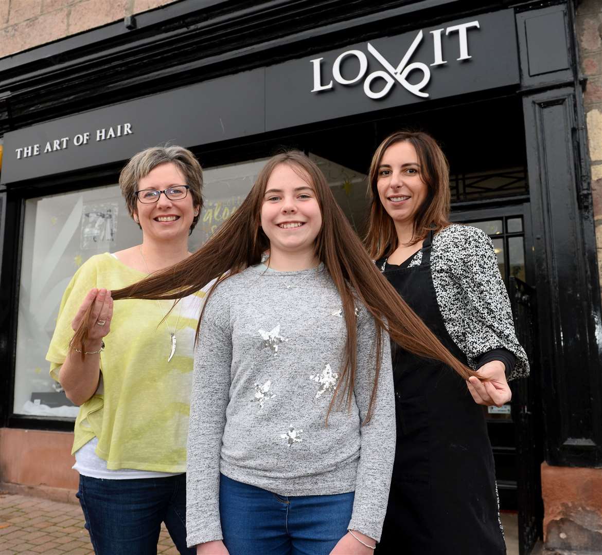 Sarah Campbell, centre, gets her ponytail cut for the Little Princess Trust charity with mum Morag, and Laura Simpson at Lovit hair salon in Beauly. Picture Gary Anthony.
