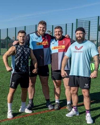 Tom and Luke Stoltman managed to dwarf the rugby stars they travelled to help.