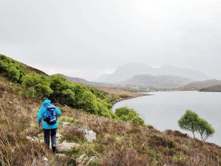 The rough path round the north side of Loch Kernsary with a view to Beinn Airigh Charr through the clouds.
