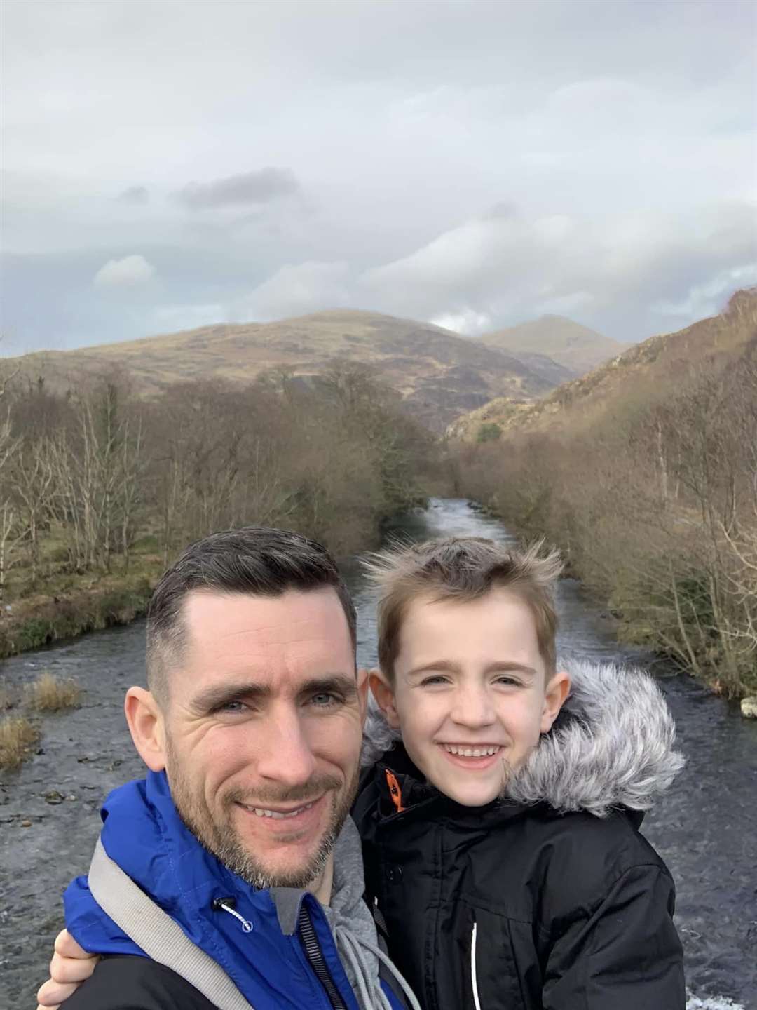Matt Burrow (left) with son, Oscar, who hiked across mountains in the UK to raise money for a hospice (Matt Burrow/PA)