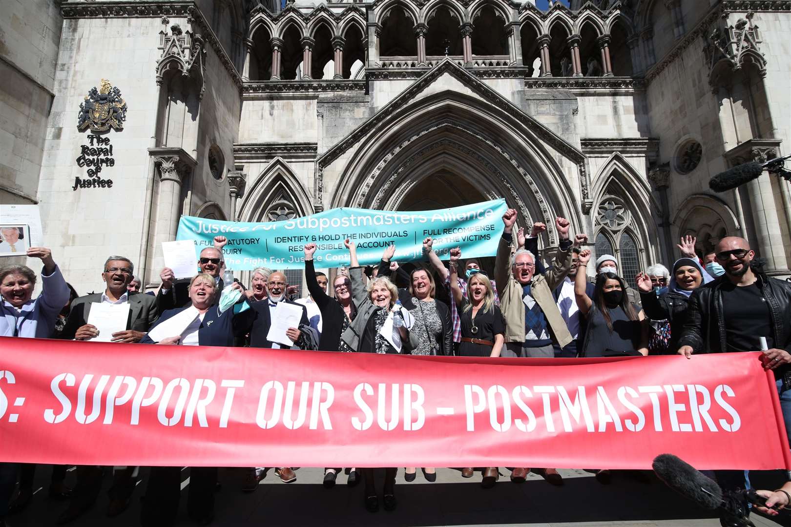 Former post office workers celebrate outside the Royal Courts of Justice (Yui Mok/PA)