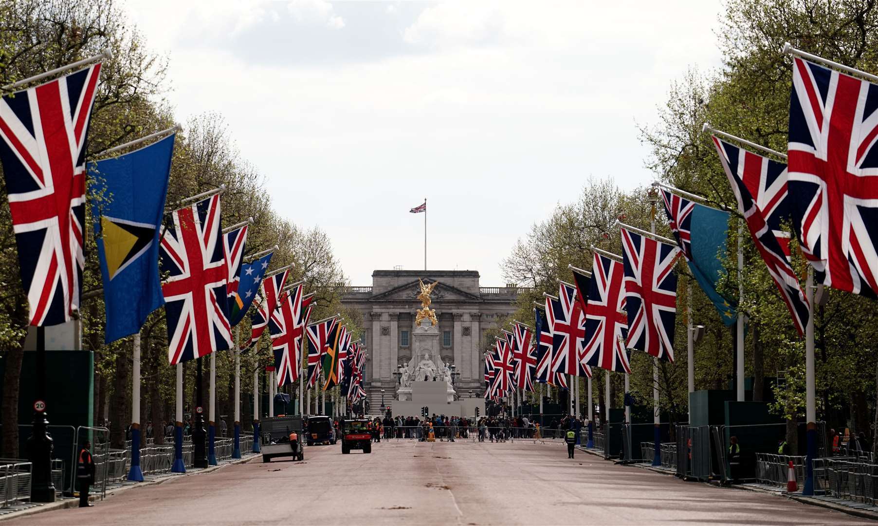 Union flags hang from the street furniture outside Buckingham Palace (Jordan Pettitt/PA)