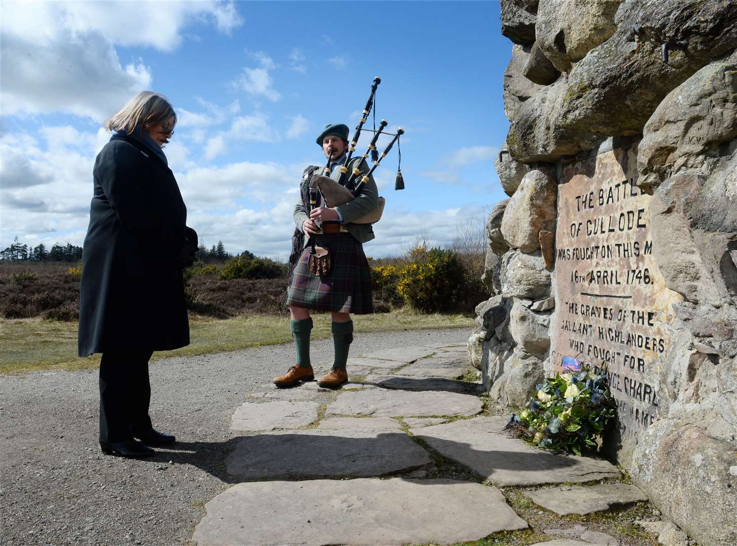 Helen Ashcroft of Inverness Outlanders pauses after laying wreath on behalf of all Outlander fans worldwide with piper and clan chief Iain MacGillivray ahead of the 275th anniversary of the Battle of Culloden. Picture: Gary Anthony