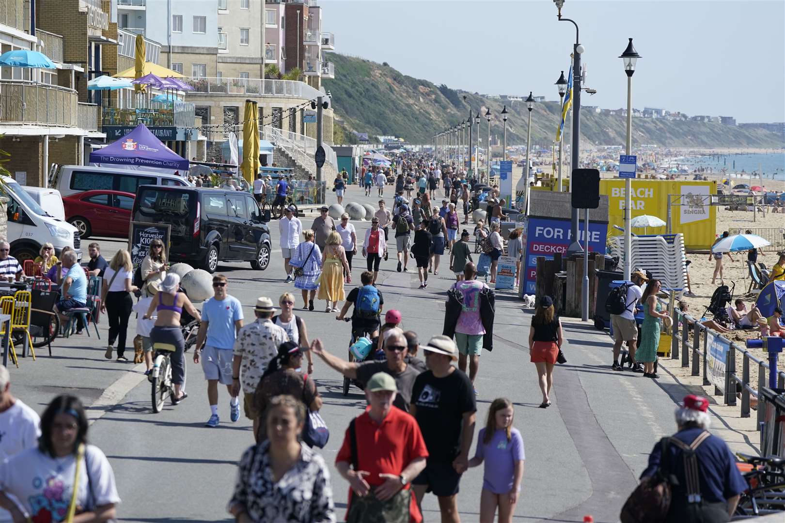 People enjoying the warm weather on the sea front at Boscombe (Andrew Matthews/PA)