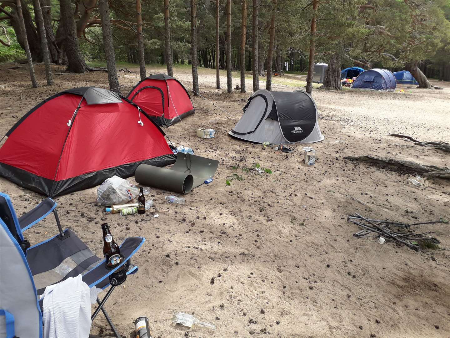 Tents, rubbish and other mess left by campers on the beach – just yards from an official campsite.