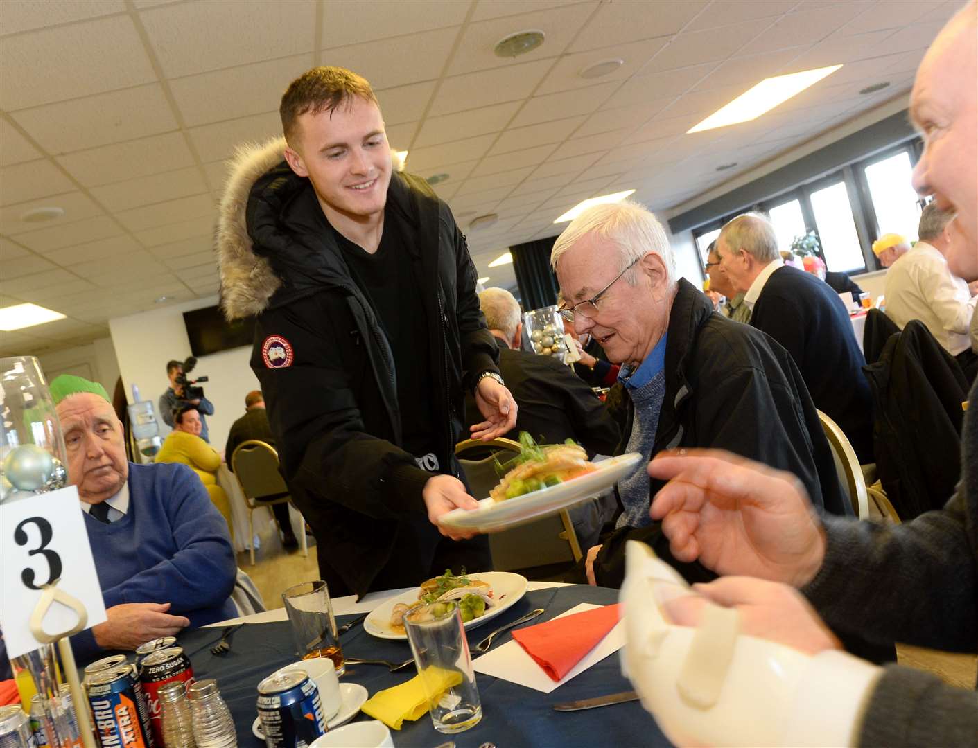 Inverness Caledonian Thistle hold a Festive Friends Christmas meal. Mich Currie helps out with serving the meals. Picture: Gary Anthony.