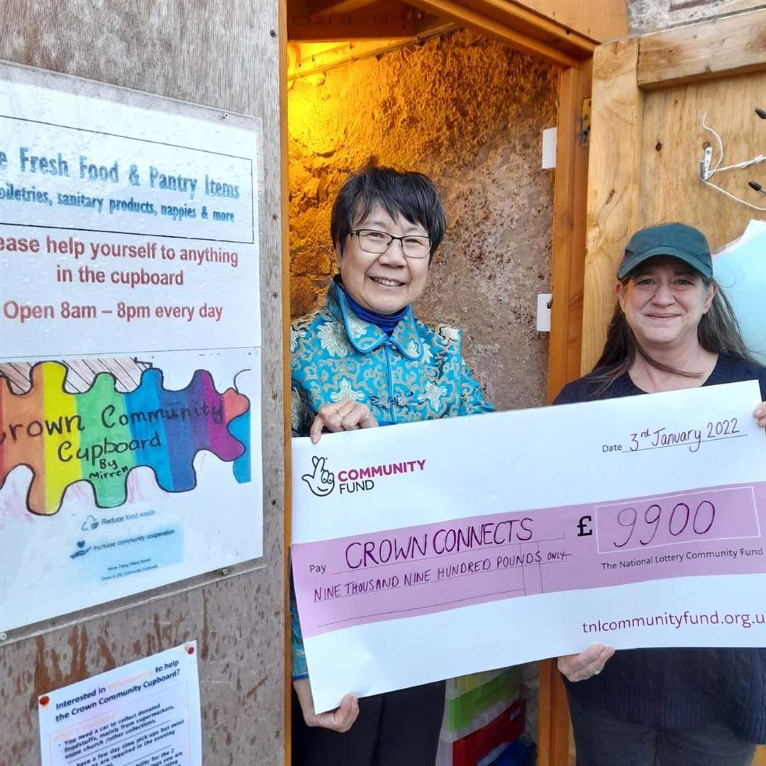 Monica Lee-Macpherson of SHIMCA and Crown Connects volunteer Sophy Edwards show off their cheque from the National Lottery Community Fund.