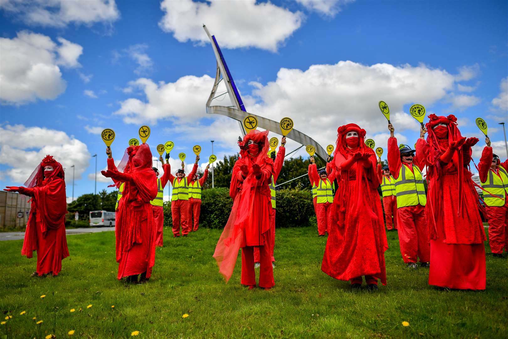 They were joined by activists dressed as runway marshals (Ben Birchall/PA)