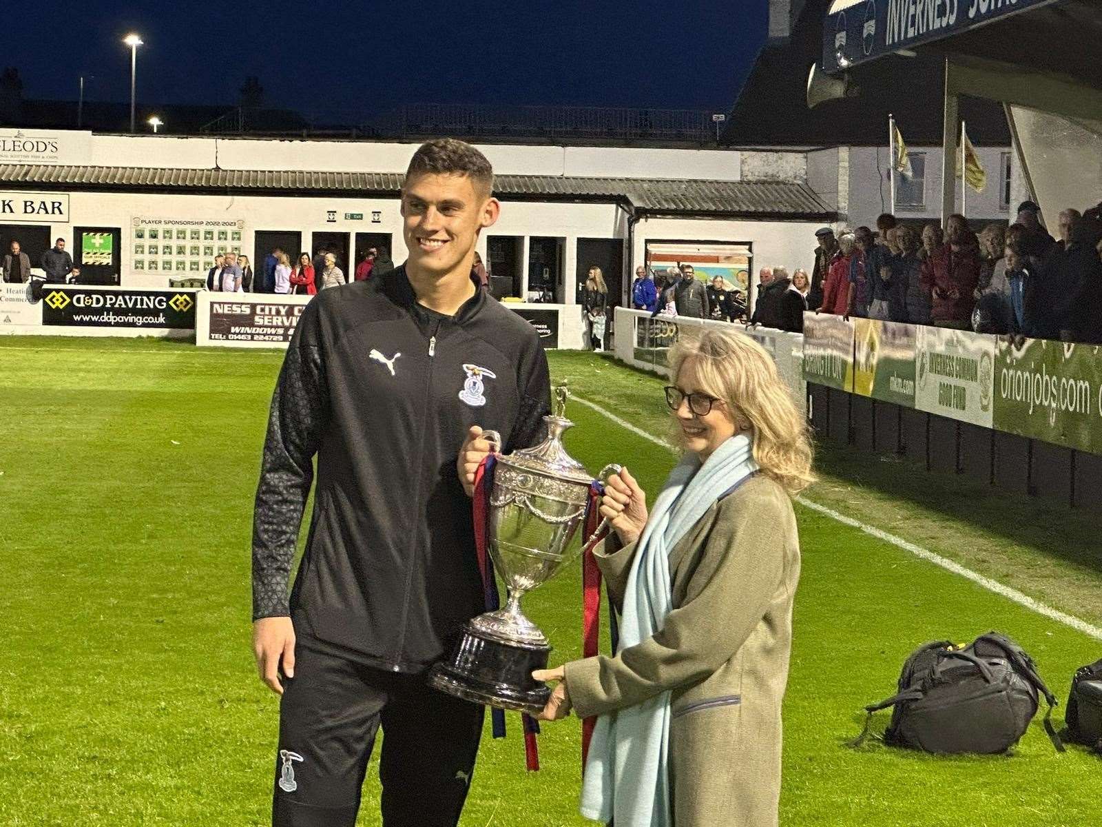 Captain for the night Wallace Duffy receives the 128-year-old trophy from provost Glynis Campbell Sinclair