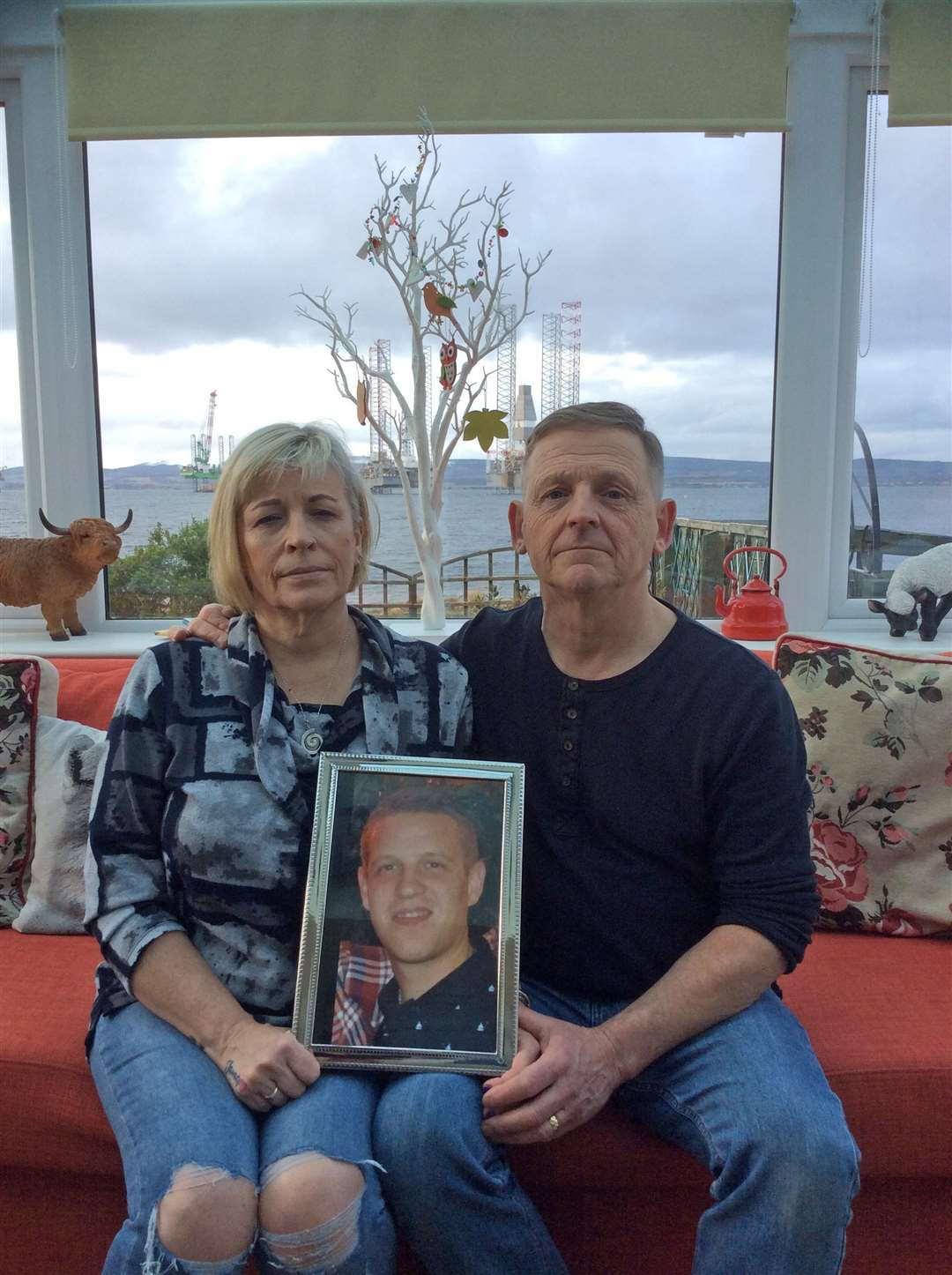 Wendy and Patrick Mullery with a photo of their son James.