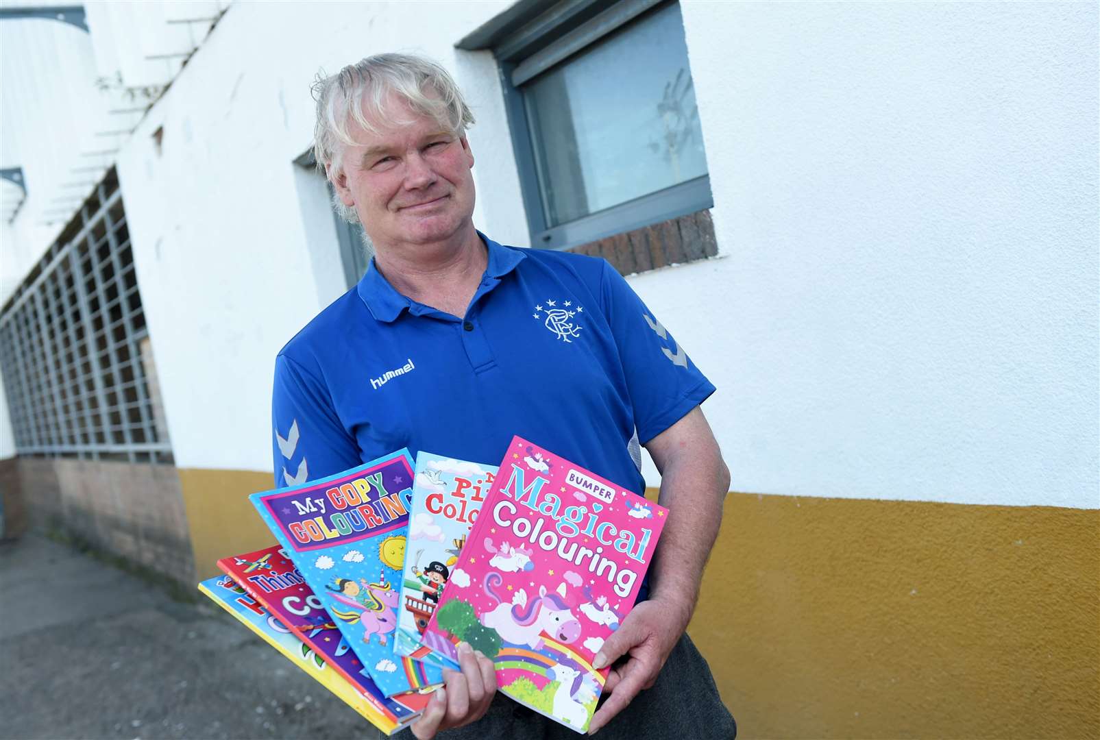 Martin Macdougall is giving away free colouring books to help out parents who are struggling to keep kids busy....Picture: Callum Mackay..