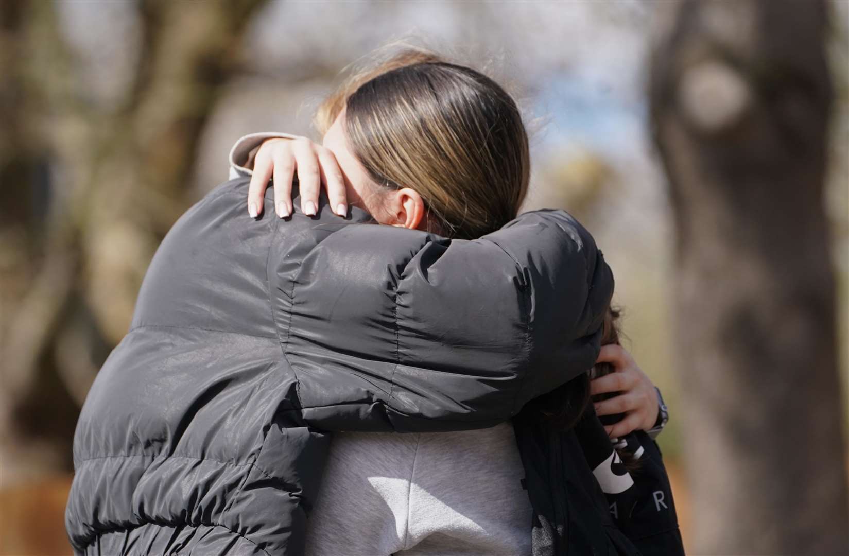 People hug at the scene in Beckton (James Manning/PA)