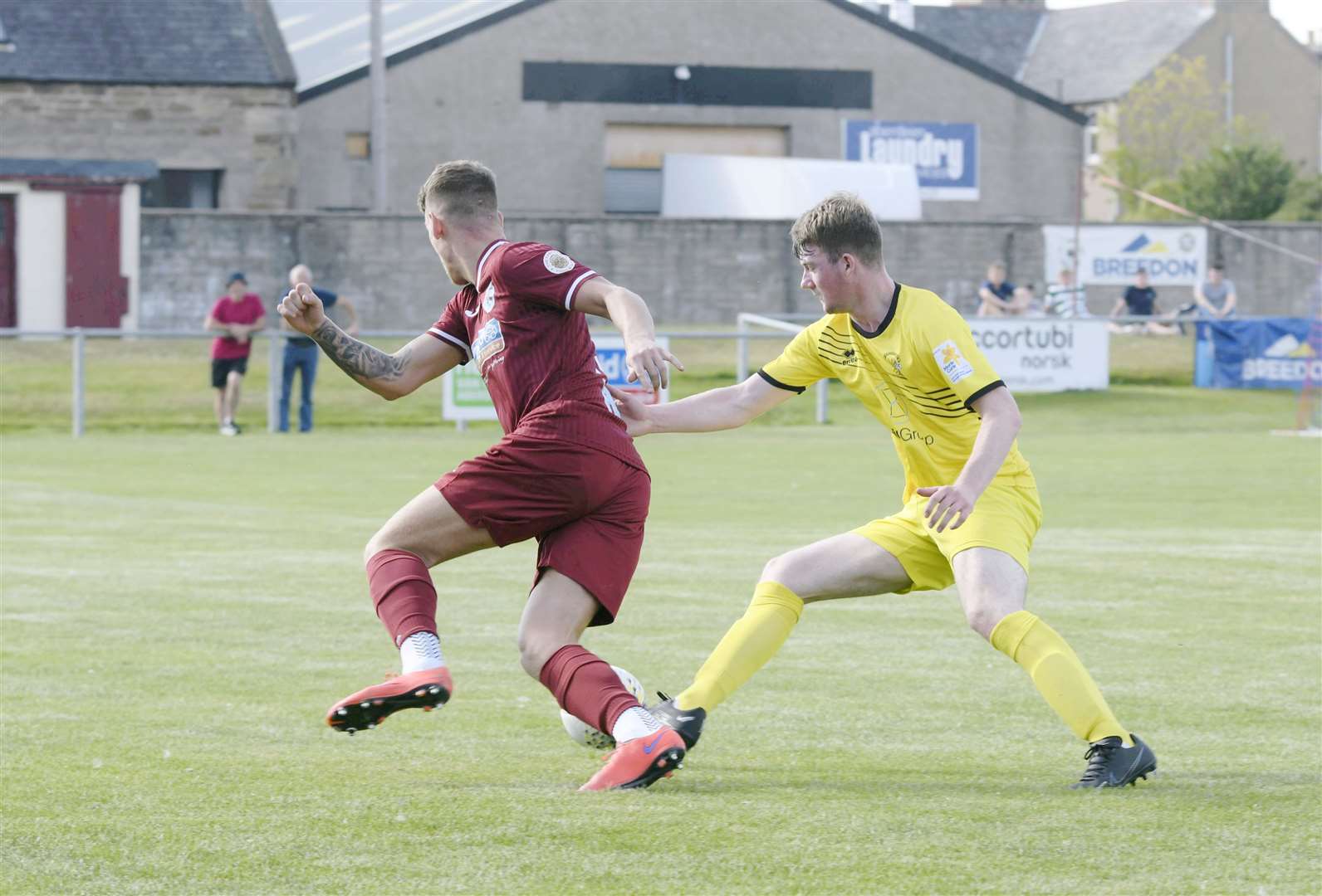 Keith's Joseph Wilson pushing through against Clach's Ben Cormack...Keith FC v Clachnacuddin FC...Picture: Beth Taylor.