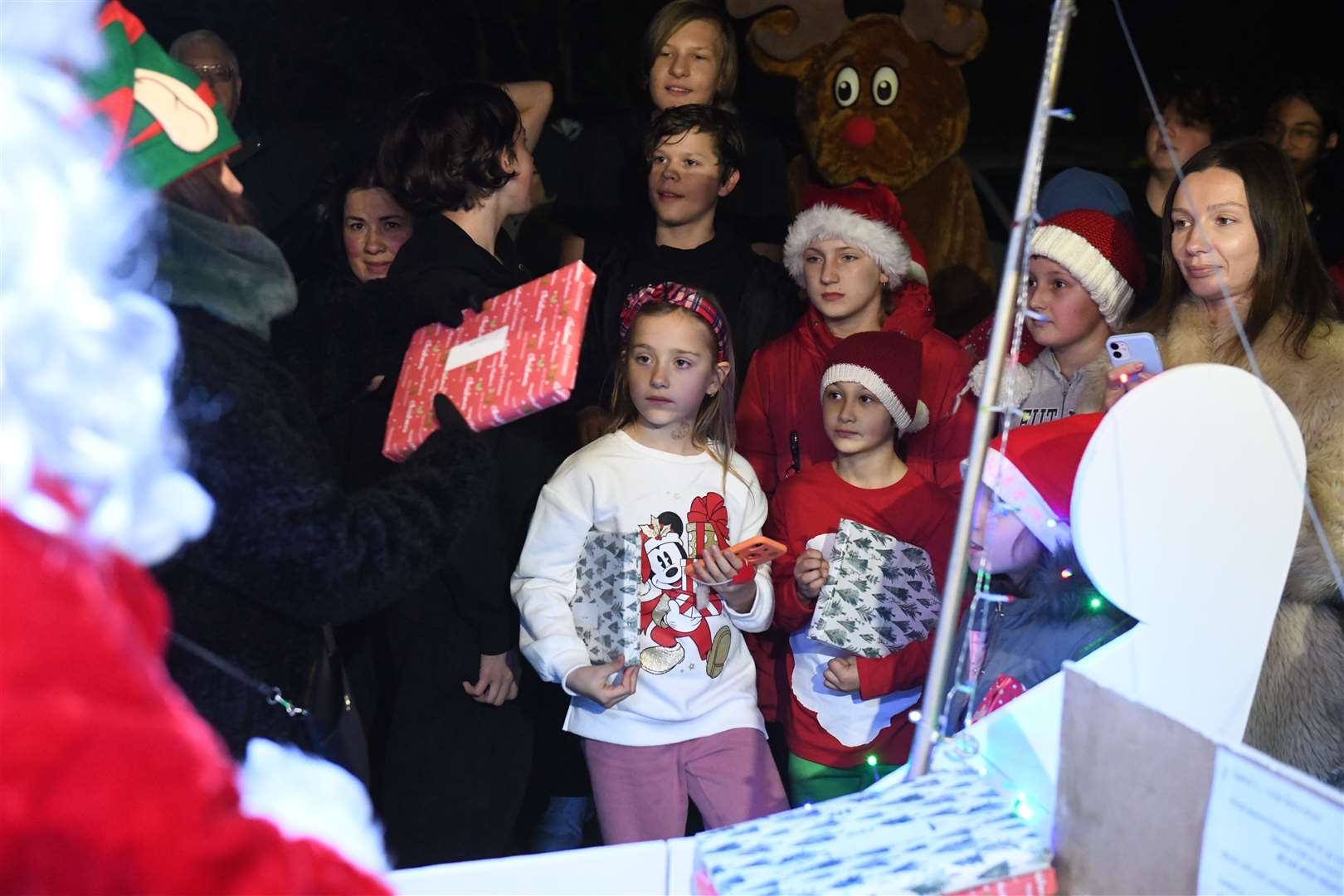 Nicola McAlley handing out the presents from Santa to the waiting children. Picture: James Mackenzie