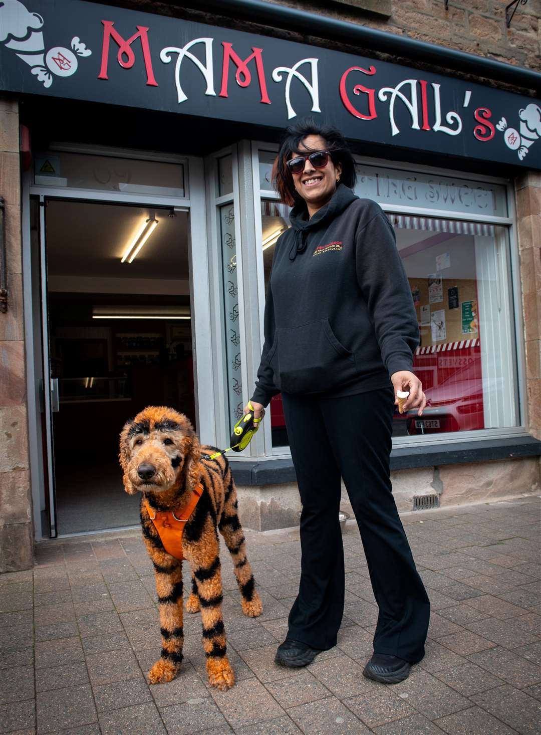 Neetu Singh from Fyrish Tandoor Alness rewards her charismatic canine Luther with an ice cream from Mama Gail's. Picture: Callum Mackay.