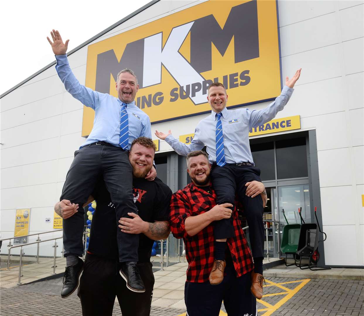MKM Inverness branch directors Mark MacDonald and Grame MacLeod get a lift from Tom and Luke Stoltman.