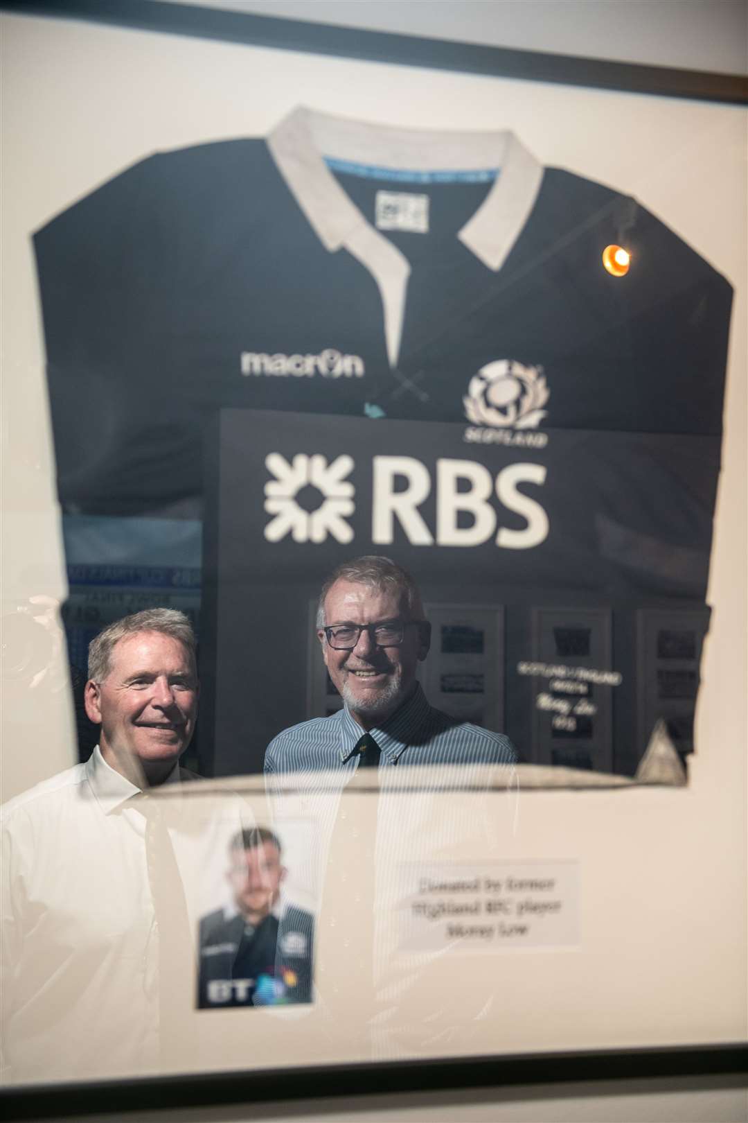 Roy Dinnes and Roy Sinclair looking at the Scotland shirt of former Highland player Moray Low. Picture: Callum Mackay..