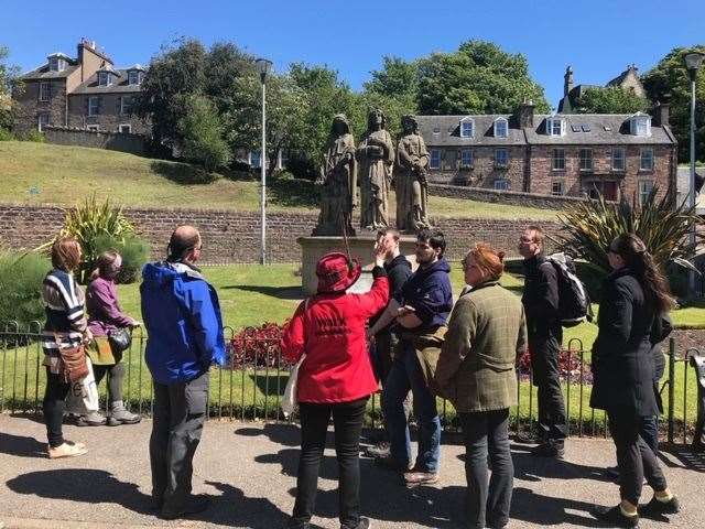 Cath showing a tour group the Three Virtues. Picture: Walk Inverness