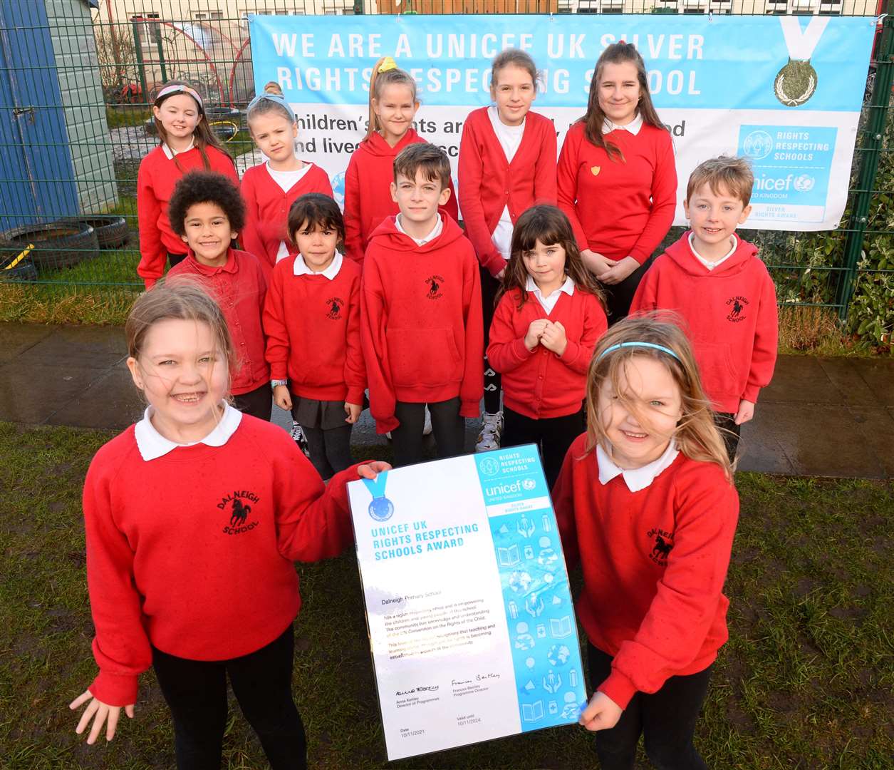 Lily and Lauren Anderson with fellow pupils of Dalneigh Primary celebrate award of UNICEF certificate.Picture Gary Anthony.