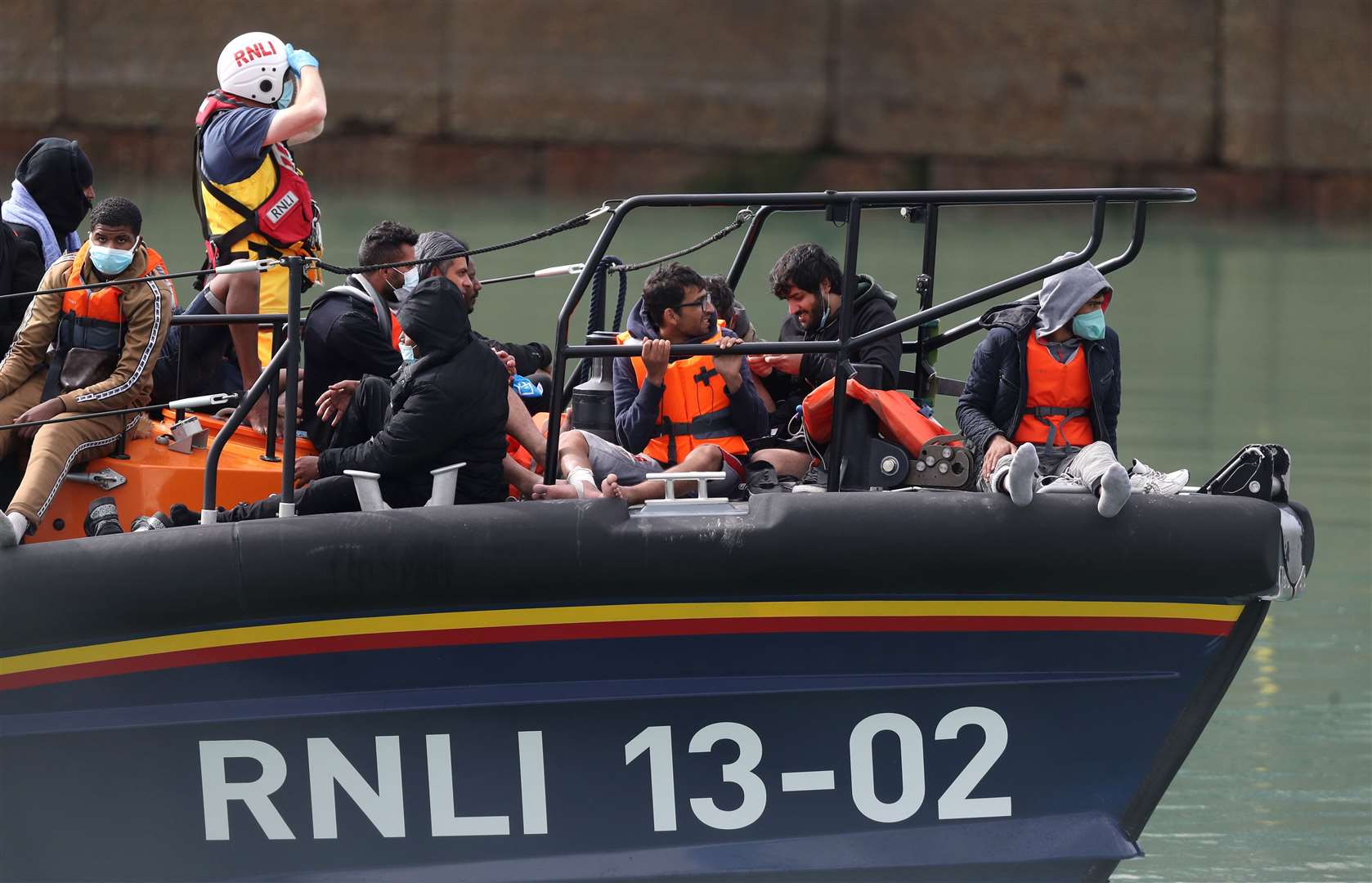 A group of people thought to be migrants are brought into Dover, Kent, by the RNLI following a small boat incident in the Channel (PA)