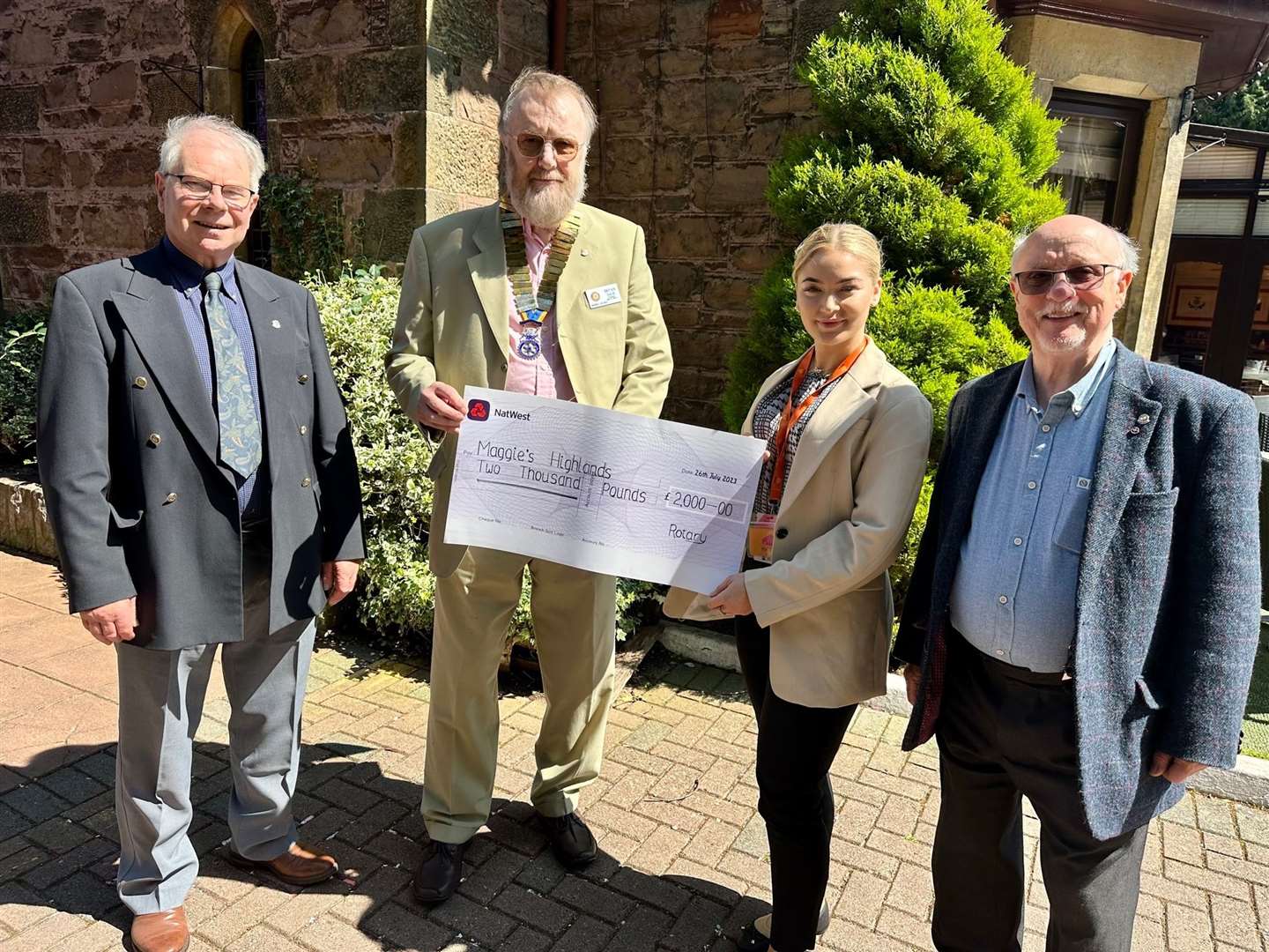 Mia Pimm, of Maggie's Highland, receives a cheque from Inverness Loch Ness Rotary Club president Bryan Smith. Also present were tour organisers Nicol Manson and Ormond Smith.