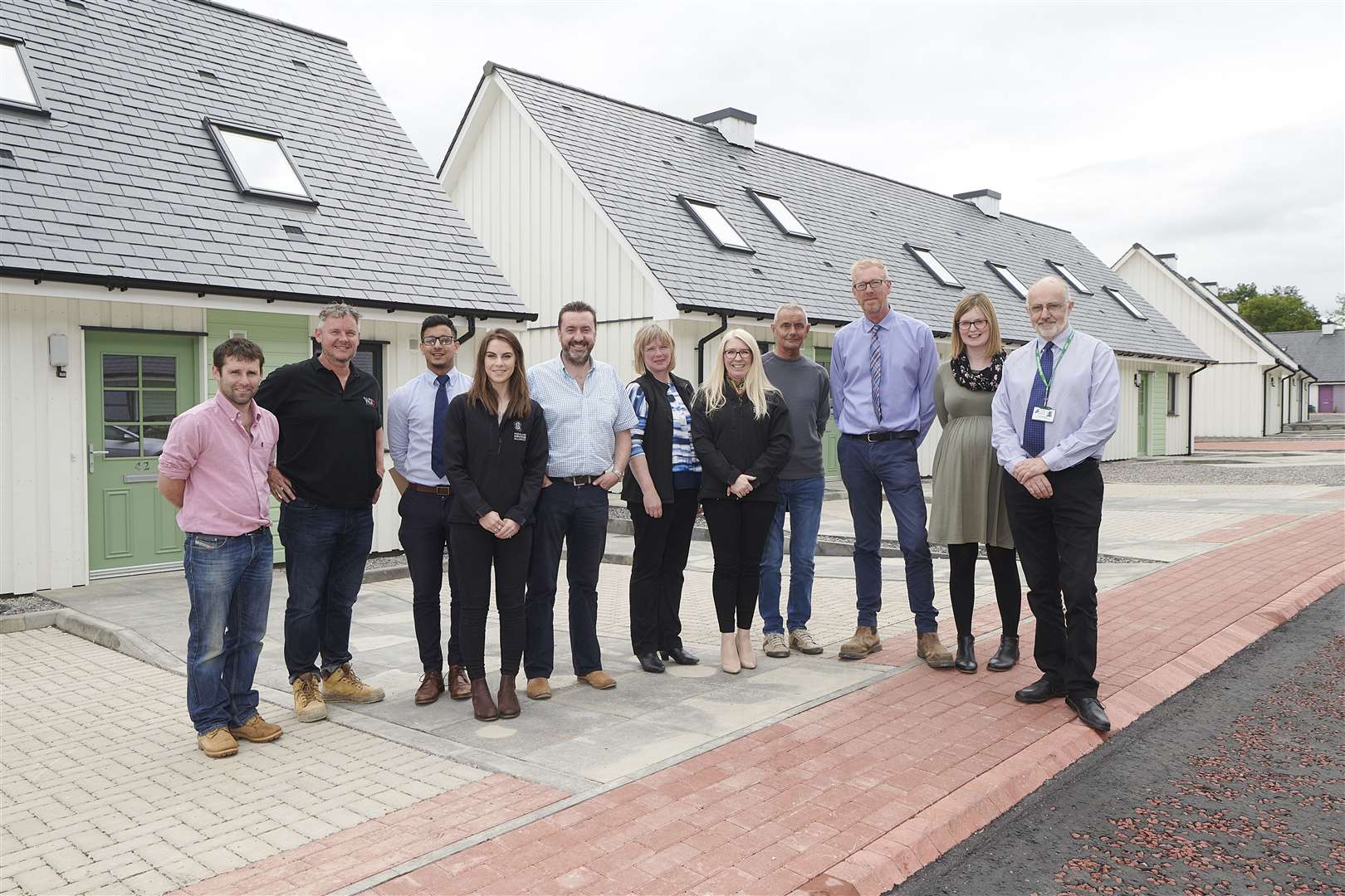 The team behind the Kiltarlity development after the last seven homes were handed over.