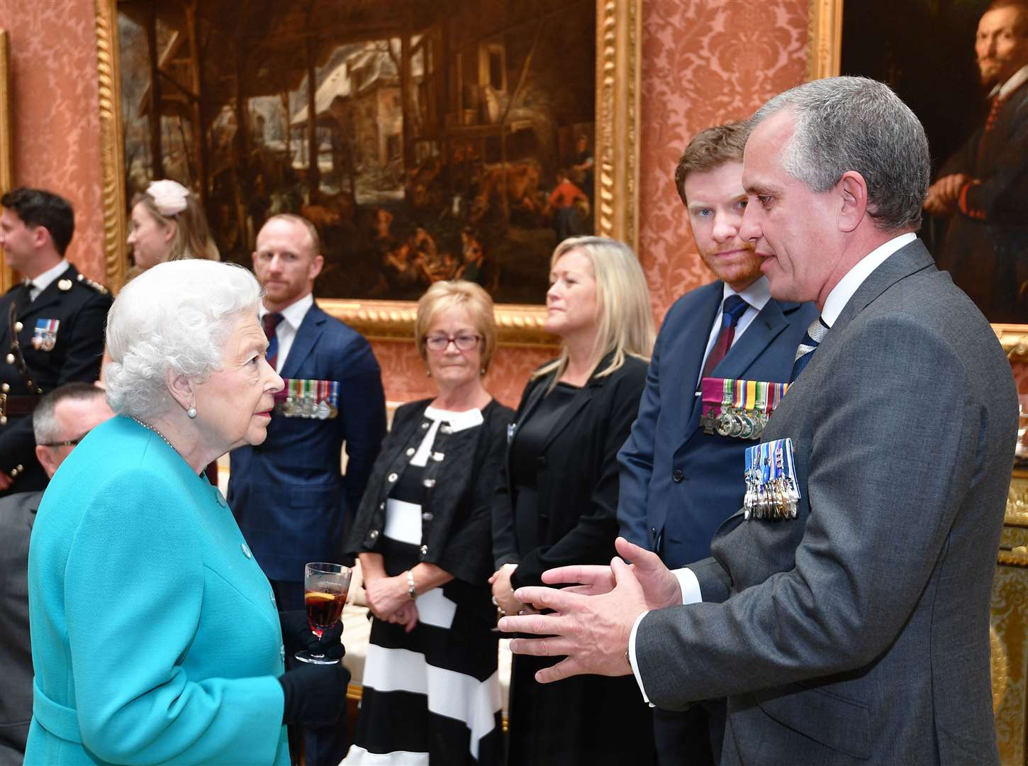 The Queen speaks to Dominic Troulan GC at Buckingham Palace (John Stillwell/PA)