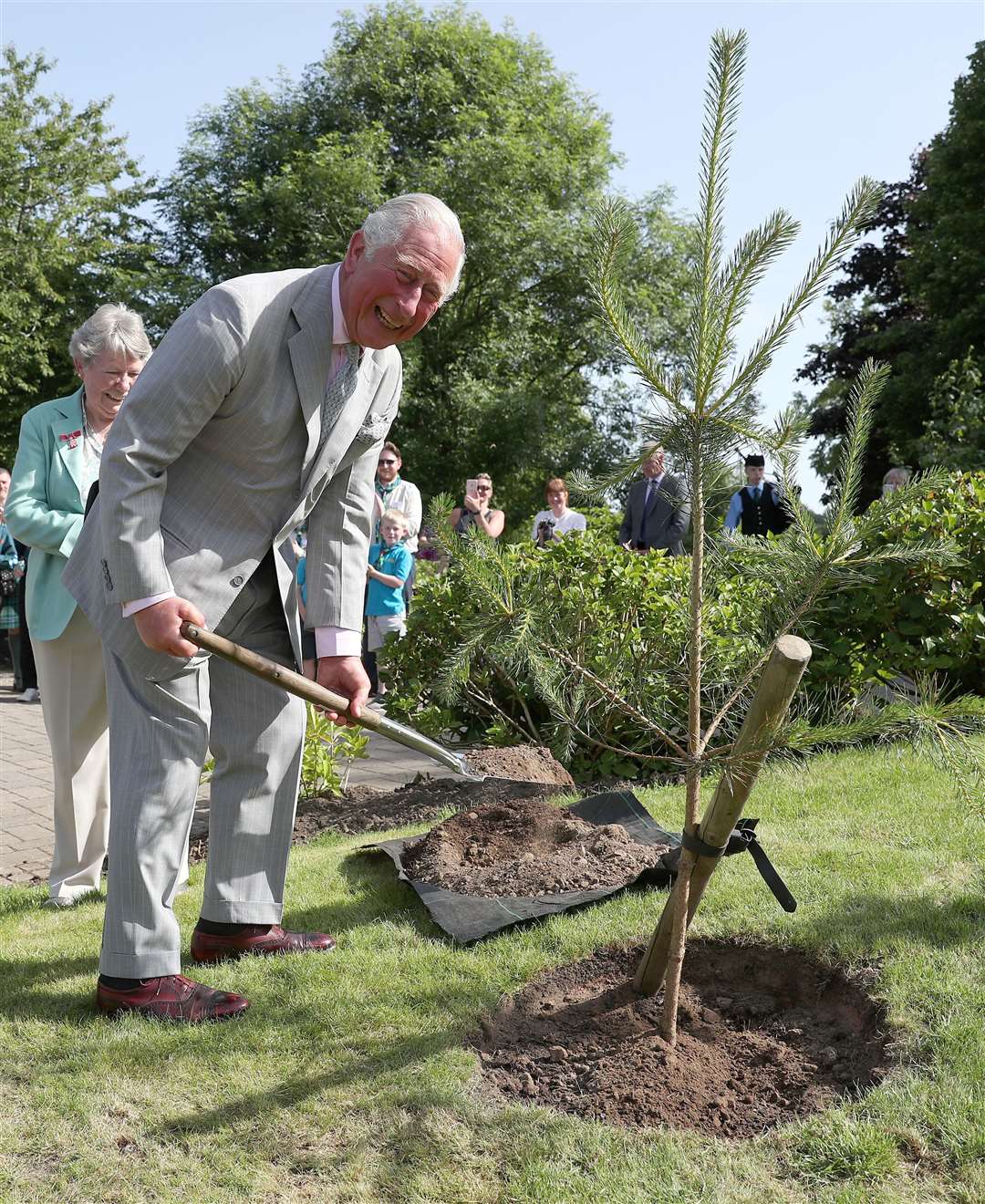 The Prince of Wales plants a tree on an engagement (Andrew Milligan/PA)